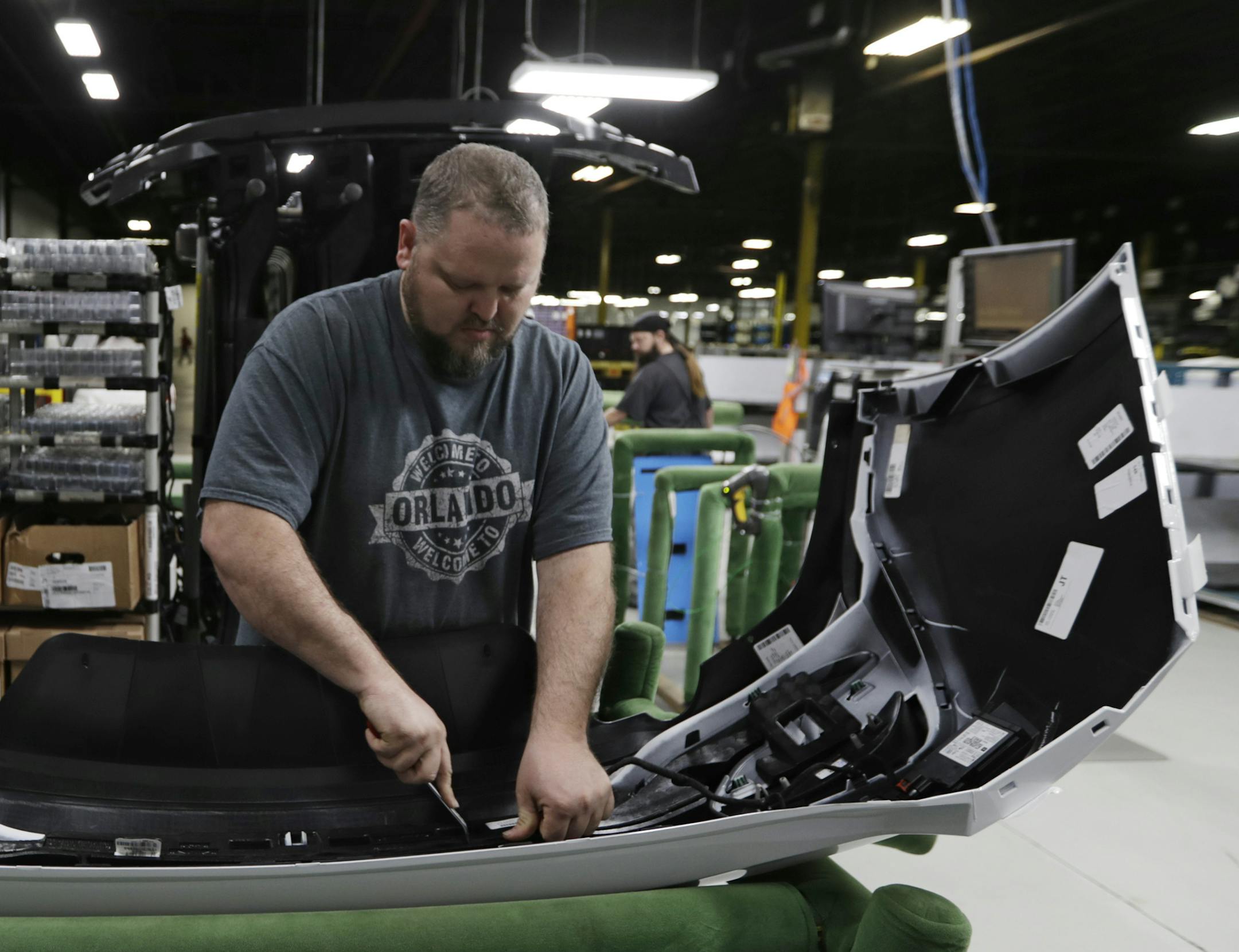 Machine operator Ed Lloyd works on the rear end of a General Motors Chevrolet Cruze at Jamestown Industries, Wednesday, Nov. 28, 2018, in Youngstown, Ohio. Jamestown Industries supplies parts for the Chevy Cruze. GM said Monday that Lordstown will stop making the Chevy Cruze by March, at a cost of 1,400 union jobs on top of the 2,700 lost there since President Donald Trump took office. (AP Photo/Tony Dejak)