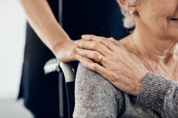 Cropped shot of a female caregiver comforting a senior woman