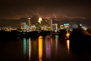 Lightning illuminated the sky above downtown Minneapolis, as seen from the Lowry Avenue Bridge, on Friday, August 14.