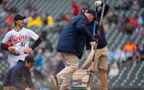 The grounds crew got plenty of work Wednesday at Target Field as the Twins and Guardians played two games in the rain. Twins pitcher Joe Ryan watches