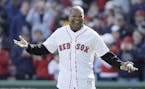 This Oct. 11, 2009 file photo shows former Red Sox outfielder Dave Henderson walking onto the field to throw out the ceremonial first pitch before Gam