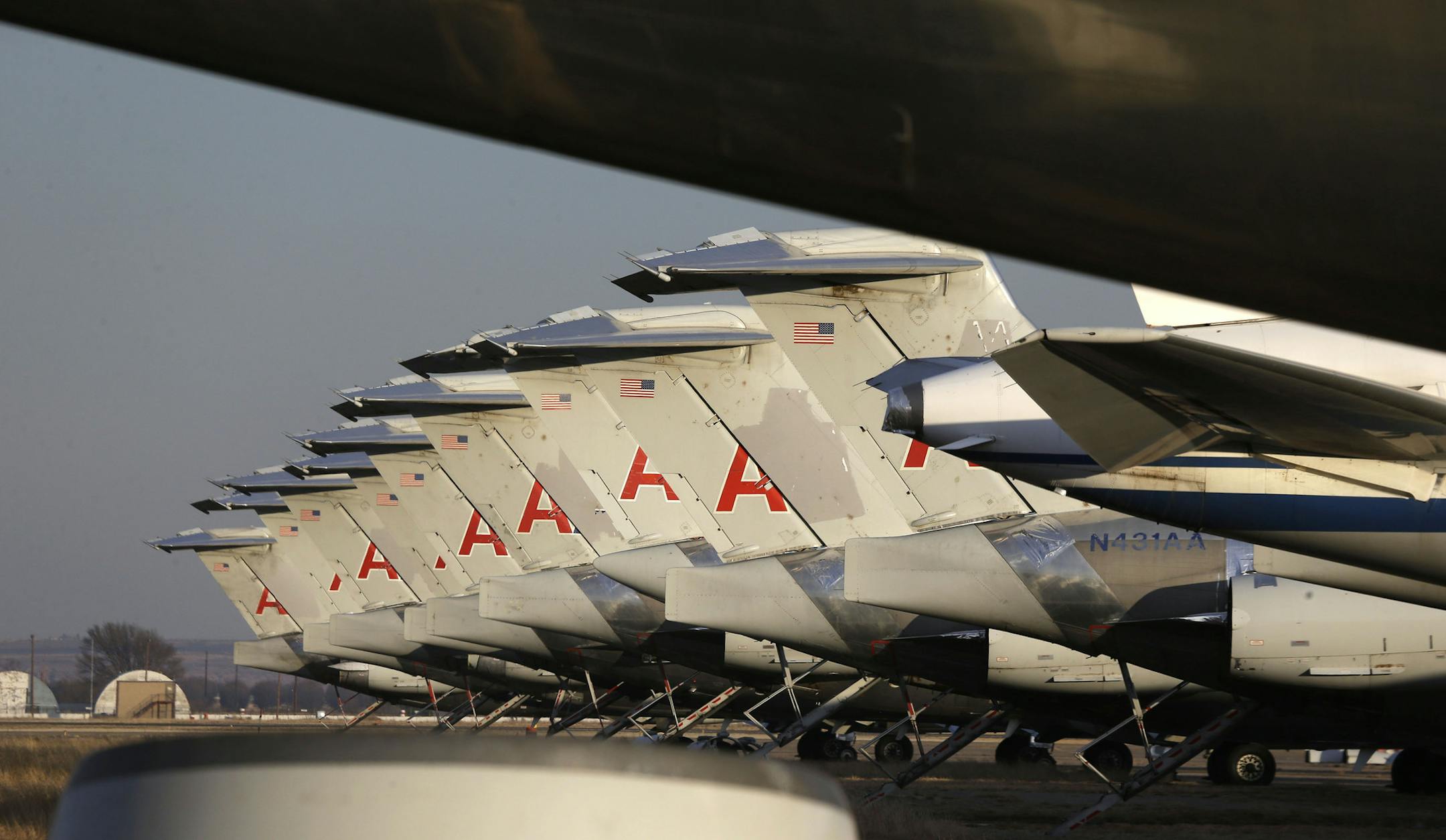 Engine-less American Airlines jets are parked in perfect rows at the airport in Roswell, N.M. Spare parts will be harvested from the planes before the carcasses are chopped up for scrap metal.
