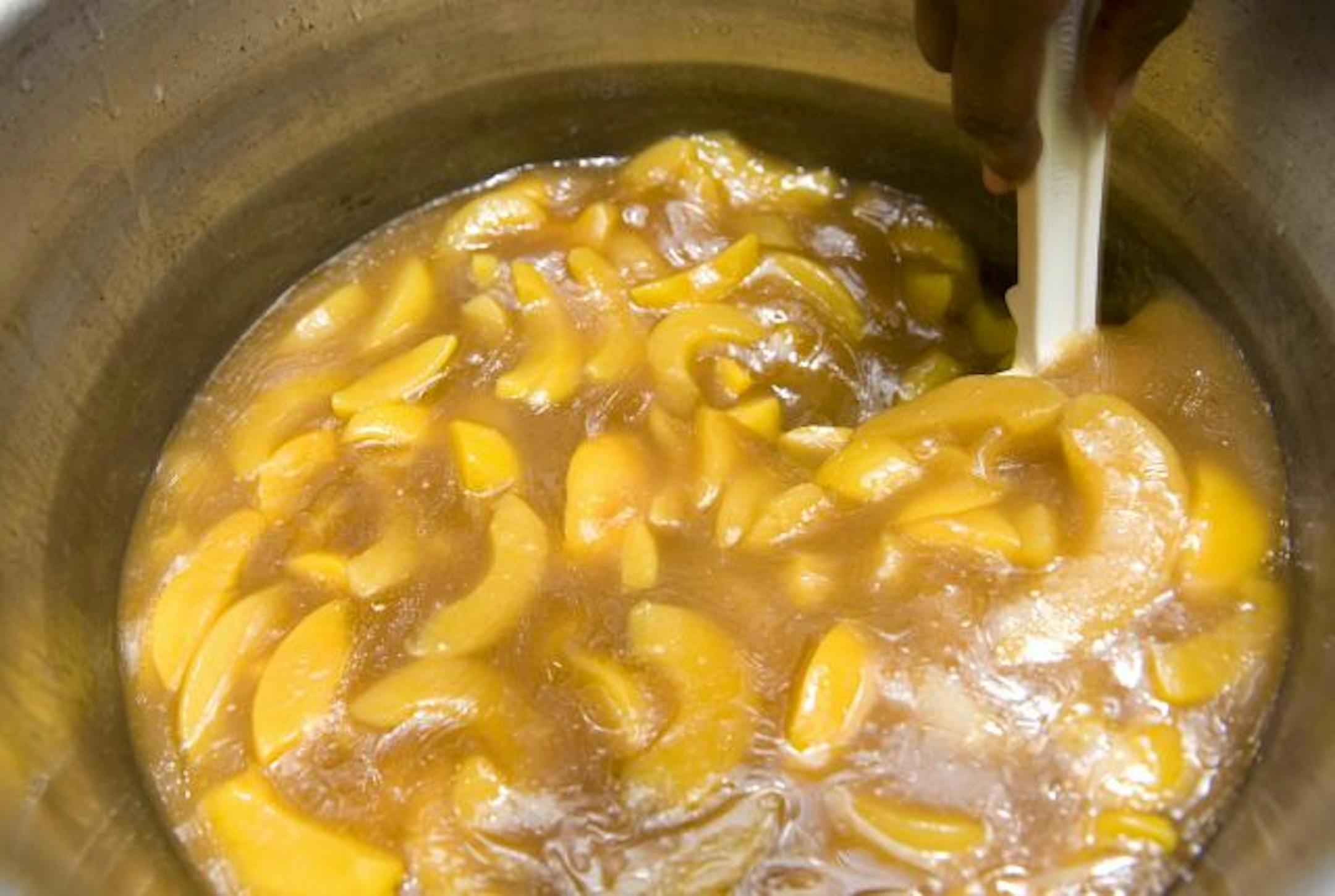 Sharon El-Amin stirred the ingredients for a pineapple peach cobbler to sell in her restaurant, El-Amin's Fish House on W. Broadway in Minneapolis. El-Amin has been nominated for an award from WomenVenture.