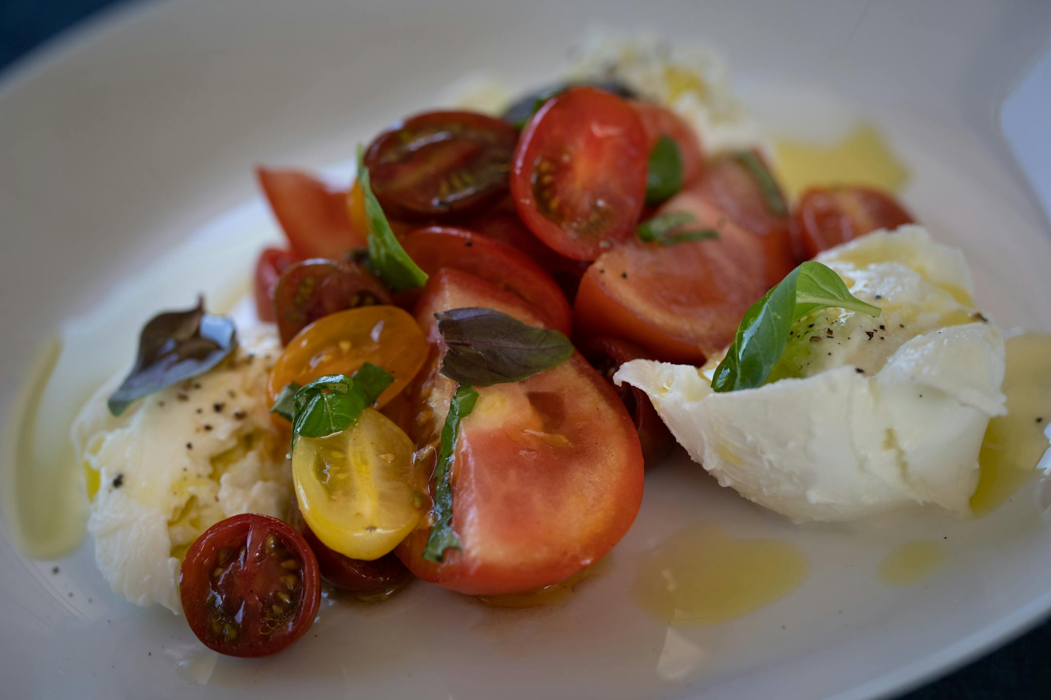 Mozzarella Di Buffalo; fresh Italian mozzarella, heirloom tomatoes, basil, drizzled with lemon oil at Gia at the Lake.
