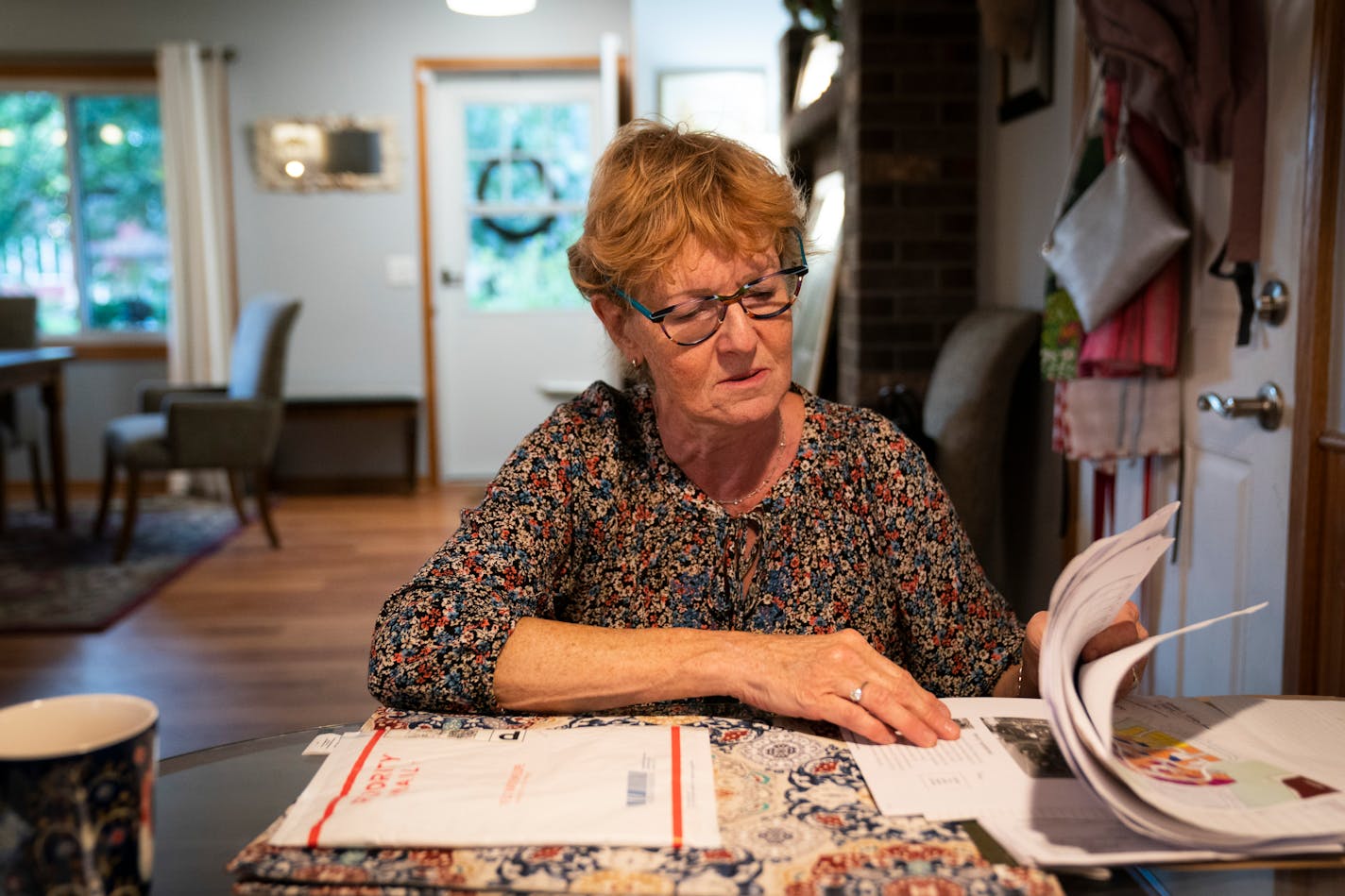 Monika Dipert looked through paperwork she has been collecting about the contaminated water in her home in Andover, Minn., on Thursday, September 23, 2021. Dipert was shocked to learn two months ago that her well water was heavily contaminated with the carcinogen dioxide likely the result of a closed landfill near her Andover home. "I can't sleep. I lay in bed and think what should I look up next," said Dipert who has become overwhelmed with what she can do to protect her health and get help from the city fixing the problem. The city has been bringing bottled water to homes in the neighborhood with high contamination.