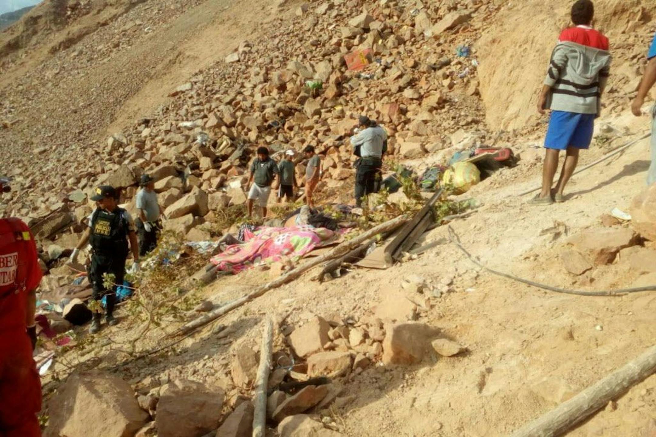 In this photo provided by the government news agency Andina, bodies of victims of a bus accident are recovered, in Arequipa, Peru, Wednesday, Feb. 21, 2018. At least 25 people were killed when their bus veered off a highway and tumbled 200 meters down a cliff.