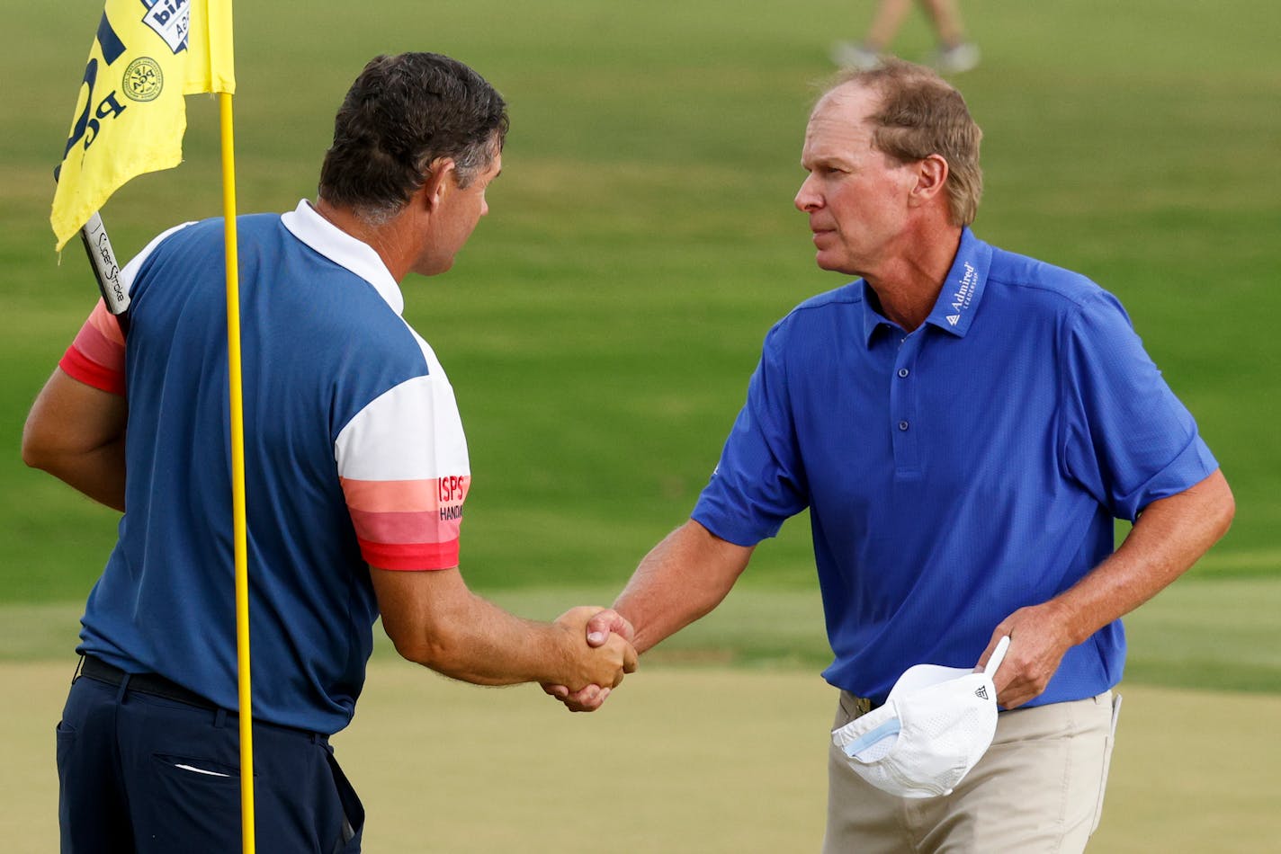 Padraig Harrington, left, of Ireland, shakes hands with Steve Stricker, of the United States, before a playoff during the final round of the Senior PGA Championship golf tournament at Fields Ranch East at PGA of America in Frisco, Texas, Sunday, May 28, 2023. (Elías Valverde II/The Dallas Morning News via AP)