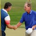 Padraig Harrington, left, of Ireland, shakes hands with Steve Stricker, of the United States, before a playoff during the final round of the Senior PG