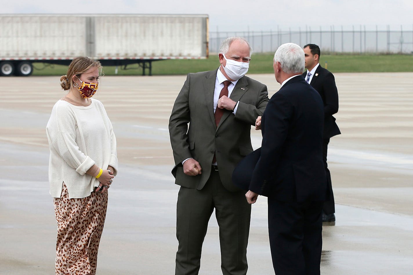 Minnesota Gov. Tim Walz, second from right, greets Vice President Mike Pence with an elbow bump as he arrives for a visit to the Mayo Clinic Tuesday, April 28, 2020, in Rochester, Minn., where he toured the facilities supporting COVID-19 research and treatment. Looking on Walz's daughter, Hope.