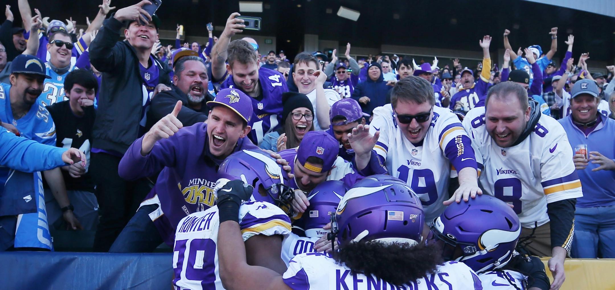 Vikings players and fans celebrated with Minnesota Vikings defensive end Ifeadi Odenigbo (95) after he returned a 56 yard fumble for a touchdown in the second quarter .
