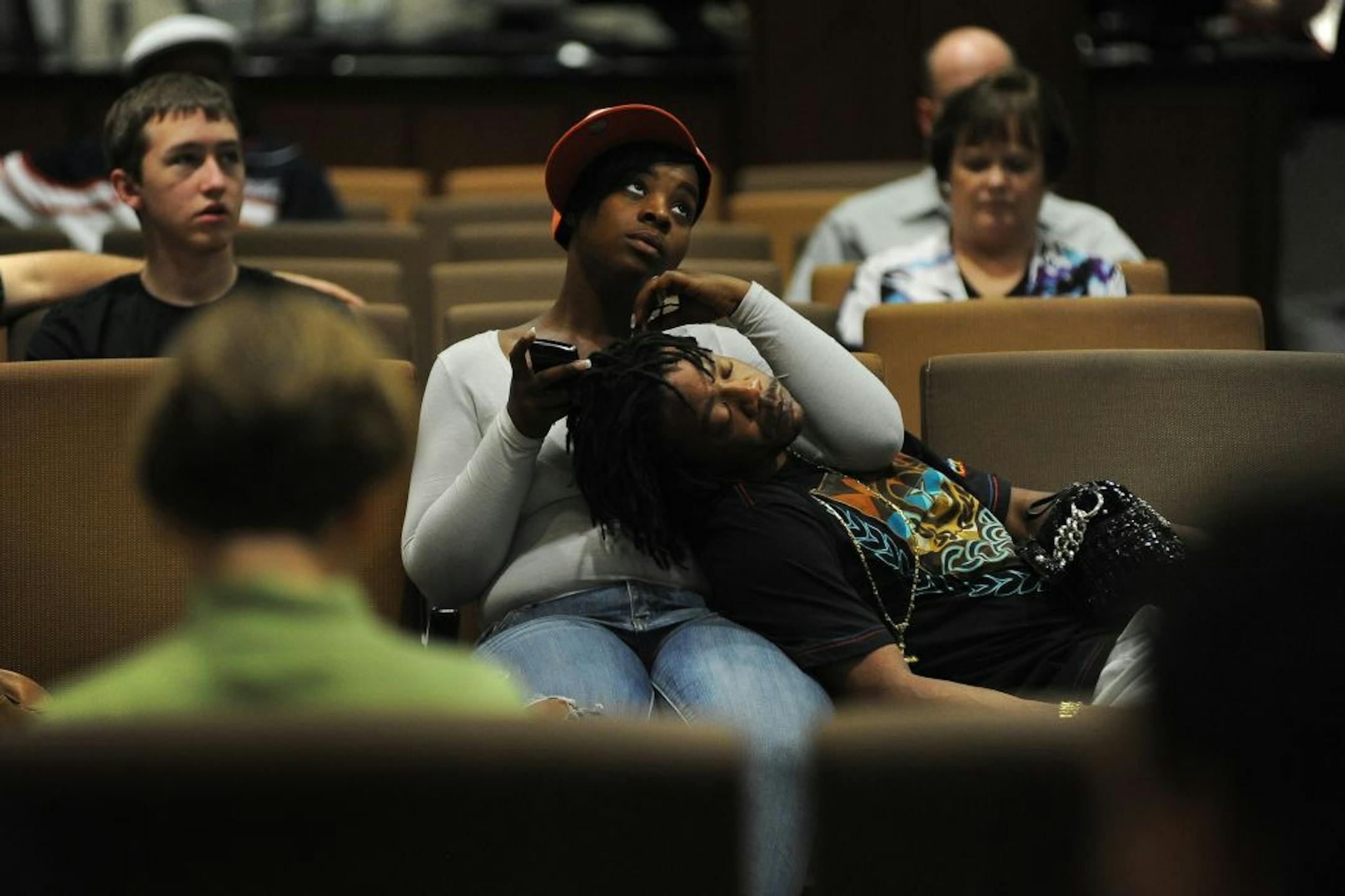 Charmaine Henry played with her boyfriend, Errol Green's, hair as they while waiting with other people for assistance at the Hennepin County Government Center. Green was waiting to get a print out of his driver's license. Green said they were there because of the possible shut down, "I'm just trying to get everything straight before they shut down," he said.