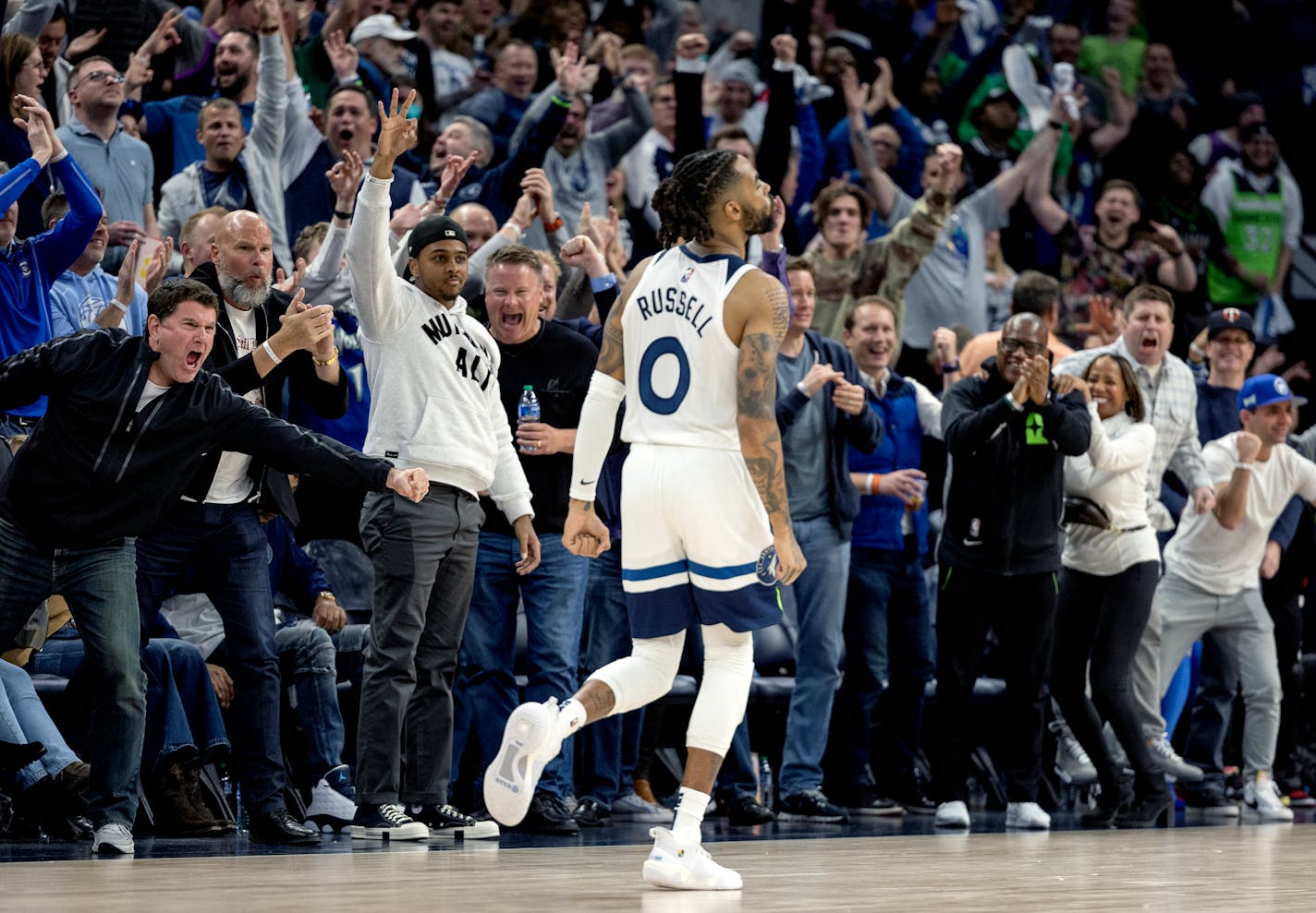 Fans celebrate a three point shot by D'Angelo Russell (0) of the Minnesota Timberwolves in the fourth quarter Tuesday, April 12, at Target Center in Minneapolis, Minn. ] CARLOS GONZALEZ • carlos.gonzalez@startribune.com