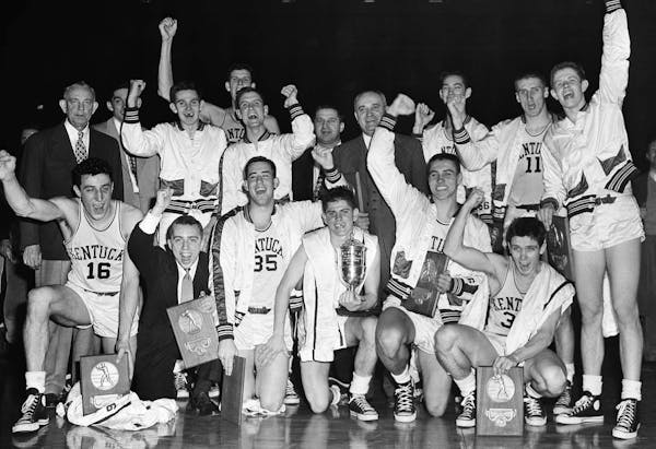 FILE - In this March 27, 1951, file photo, the Kentucky basketball team celebrates winning the NCAA college basketball championship after defeating Ka