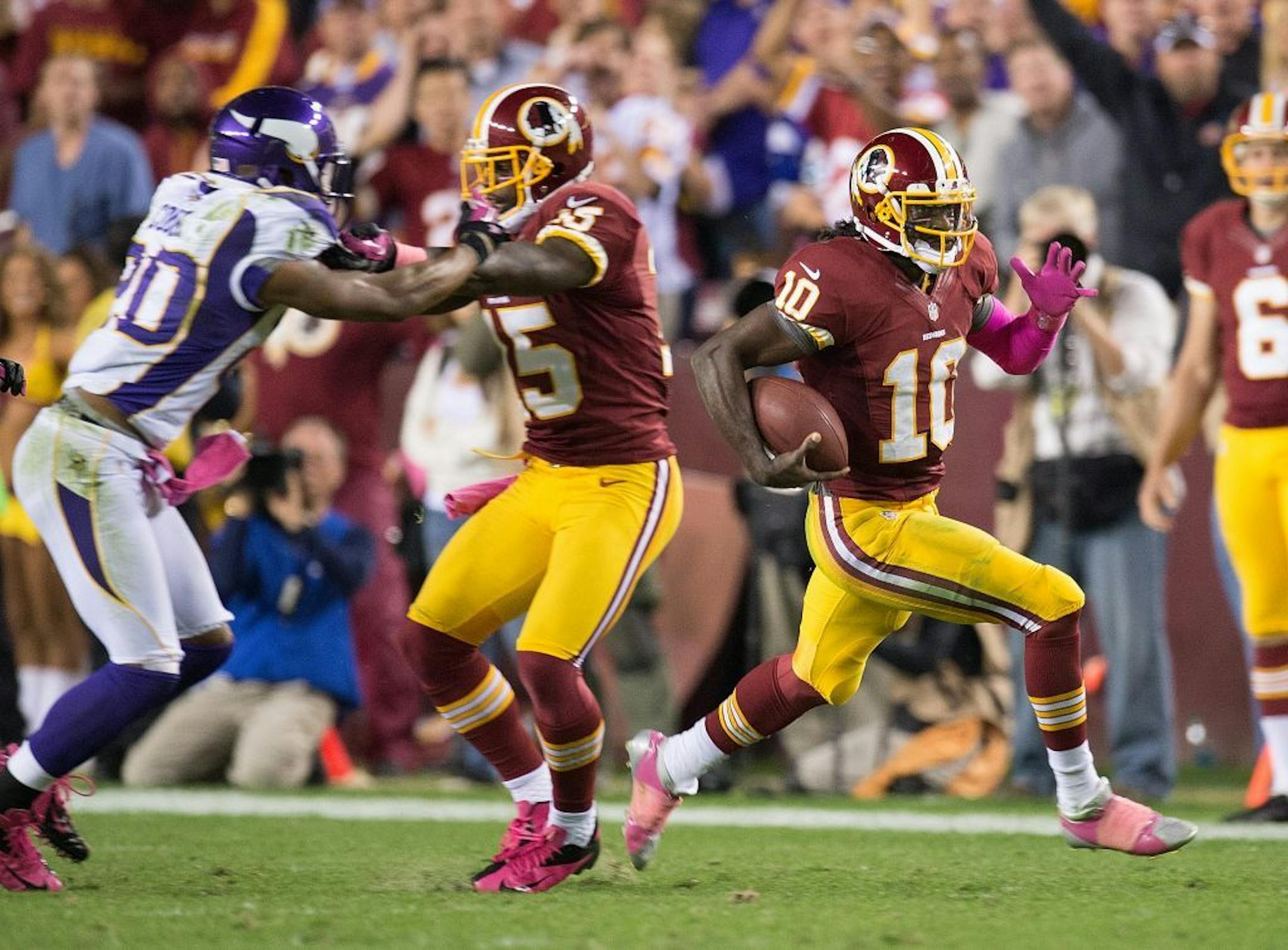 Washington Redskins quarterback Robert Griffin III (10) get a block as he turns the corner for a long touchdown run against the Minnesota Vikings during the second half at FedEx Field in Landover, MD, Sunday, October 14, 2012. Washington defeated Minnesota 38-26.
