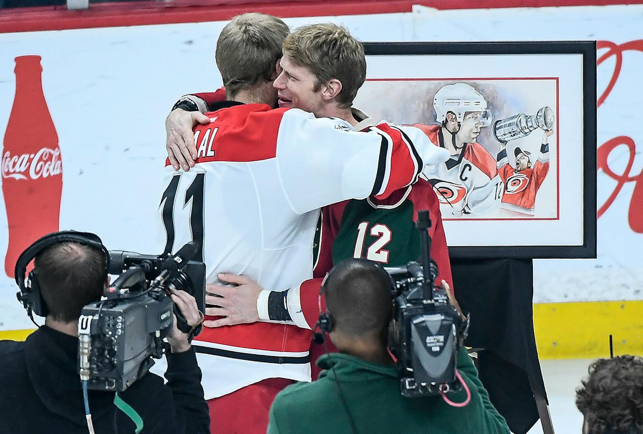 Minnesota Wild center Eric Staal (12) hugged his brother, Carolina Hurricanes center Jordan Staal (11), after a ceremony dedicated to Eric Staal in honor of his 1000th NHL game. ]