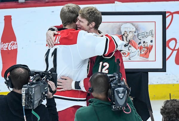 Minnesota Wild center Eric Staal (12) hugged his brother, Carolina Hurricanes center Jordan Staal (11), after a ceremony dedicated to Eric Staal in ho