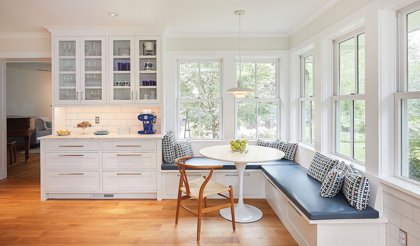 The Seefeldts' remodeled kitchen has a built-in banquette and walls of windows overlooking their garden, which they created as a tribute to their late daughter.