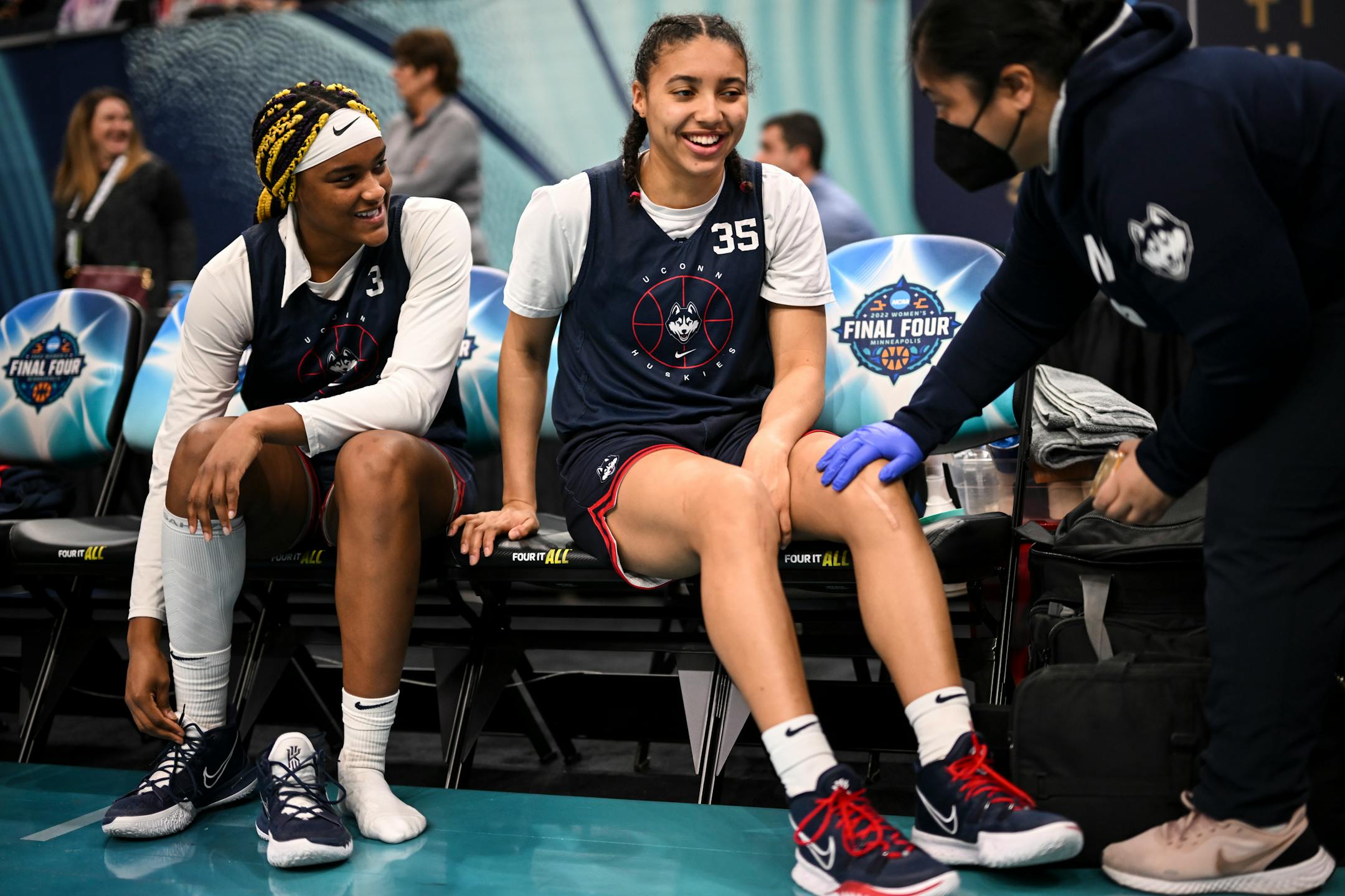 An athletic trainer works with UConn forward Aaliyah Edwards (3) and guard Azzi Fudd (35) during a Final Four open practice held Saturday, April 2, 2022 at Target Center in Minneapolis, Minn.