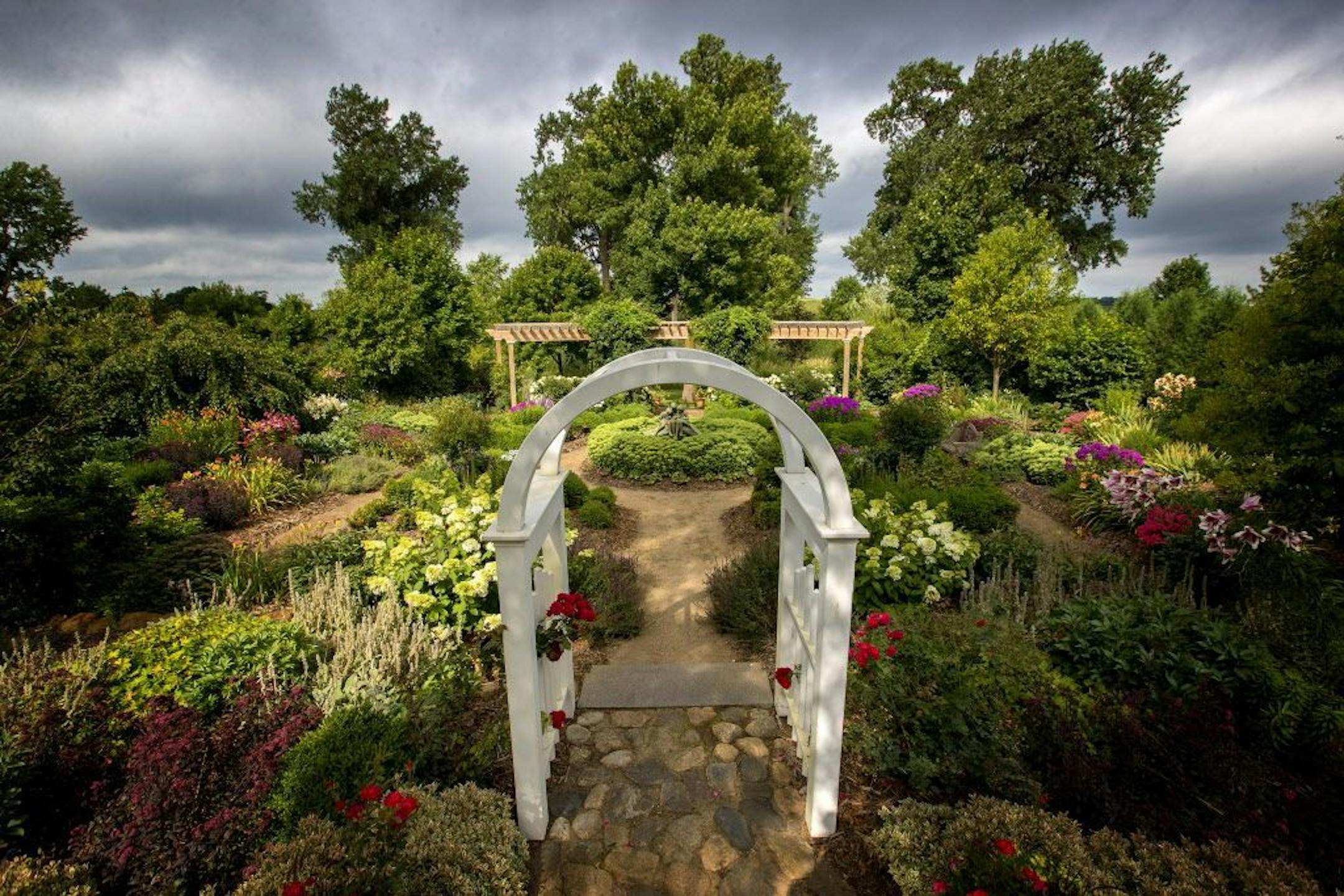 An arbor marks the entrance to Brad and Debbie Young's sunken garden of rainbow-hued perennials in Cokato. It's one of six gardens chosen from 150 nominations received by the Star Tribune last summer in the annual Beautiful Gardens contest.
