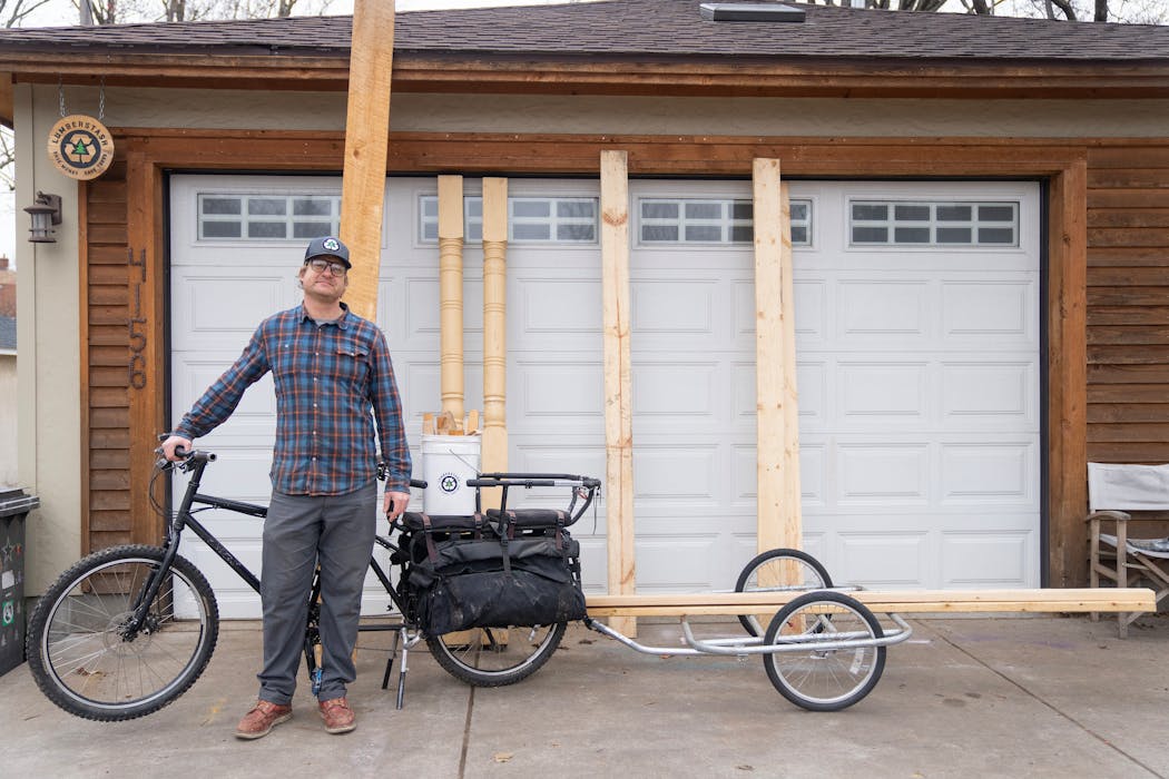 Jeremy Marshik, founder of LumberStash, uses his cargo bike to retrieve wood from dumpsters and bring it to his home in Minneapolis.
