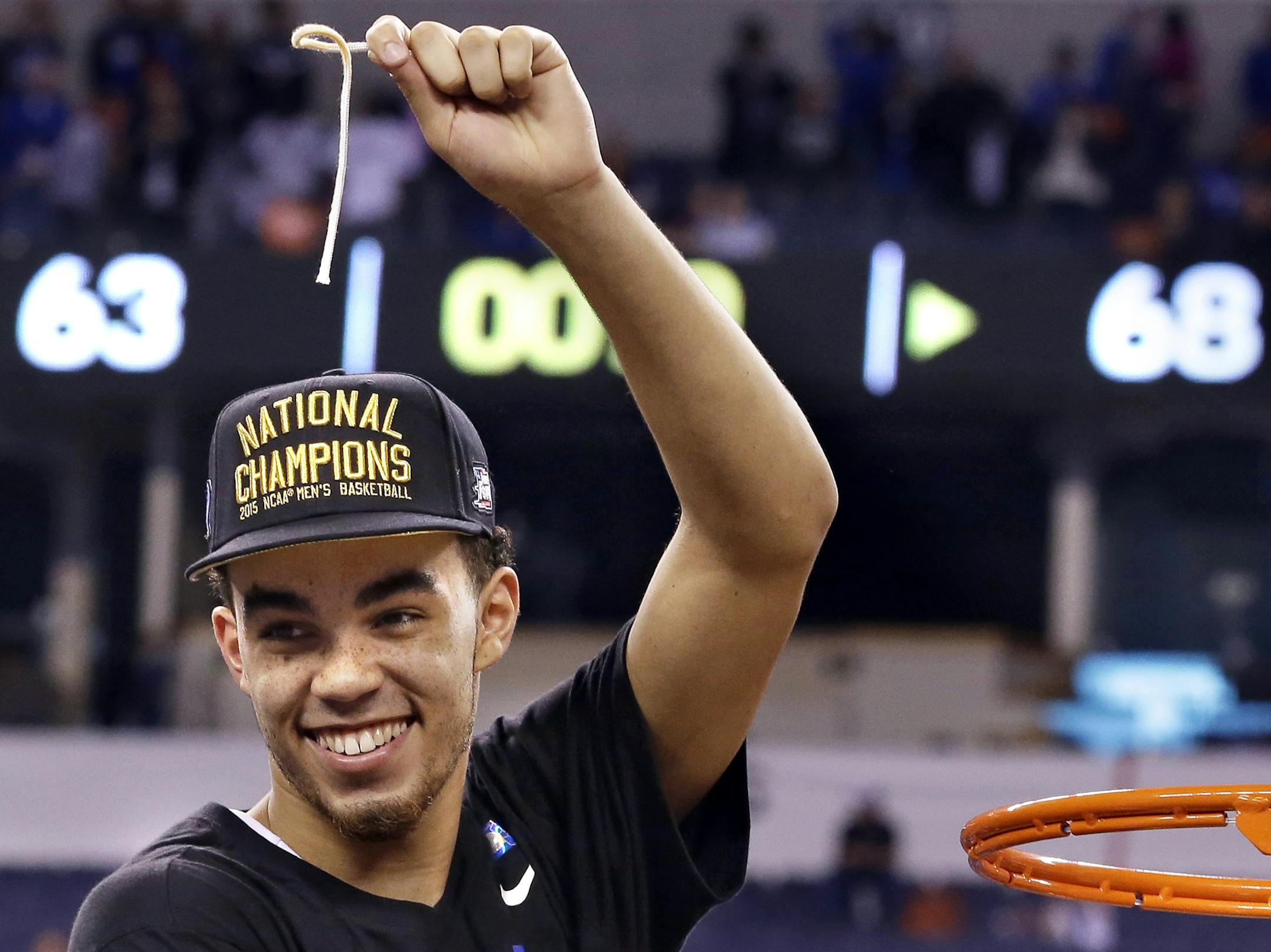 Duke's Tyus Jones cuts down the net after his team's 68-63 victory over Wisconsin in the NCAA Final Four college basketball tournament championship game Monday, April 6, 2015, in Indianapolis. (AP Photo/David J. Phillip) ORG XMIT: MIN2015040623545896