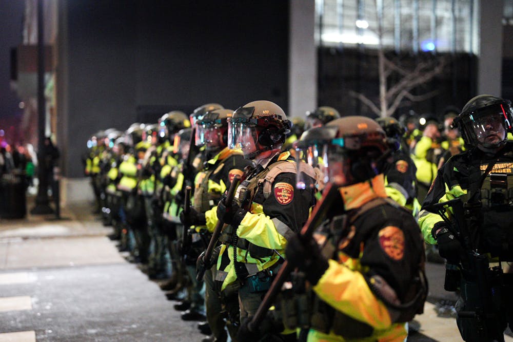 Law enforcement officers line up during a protest in downtown Minneapolis on Jan. 9.