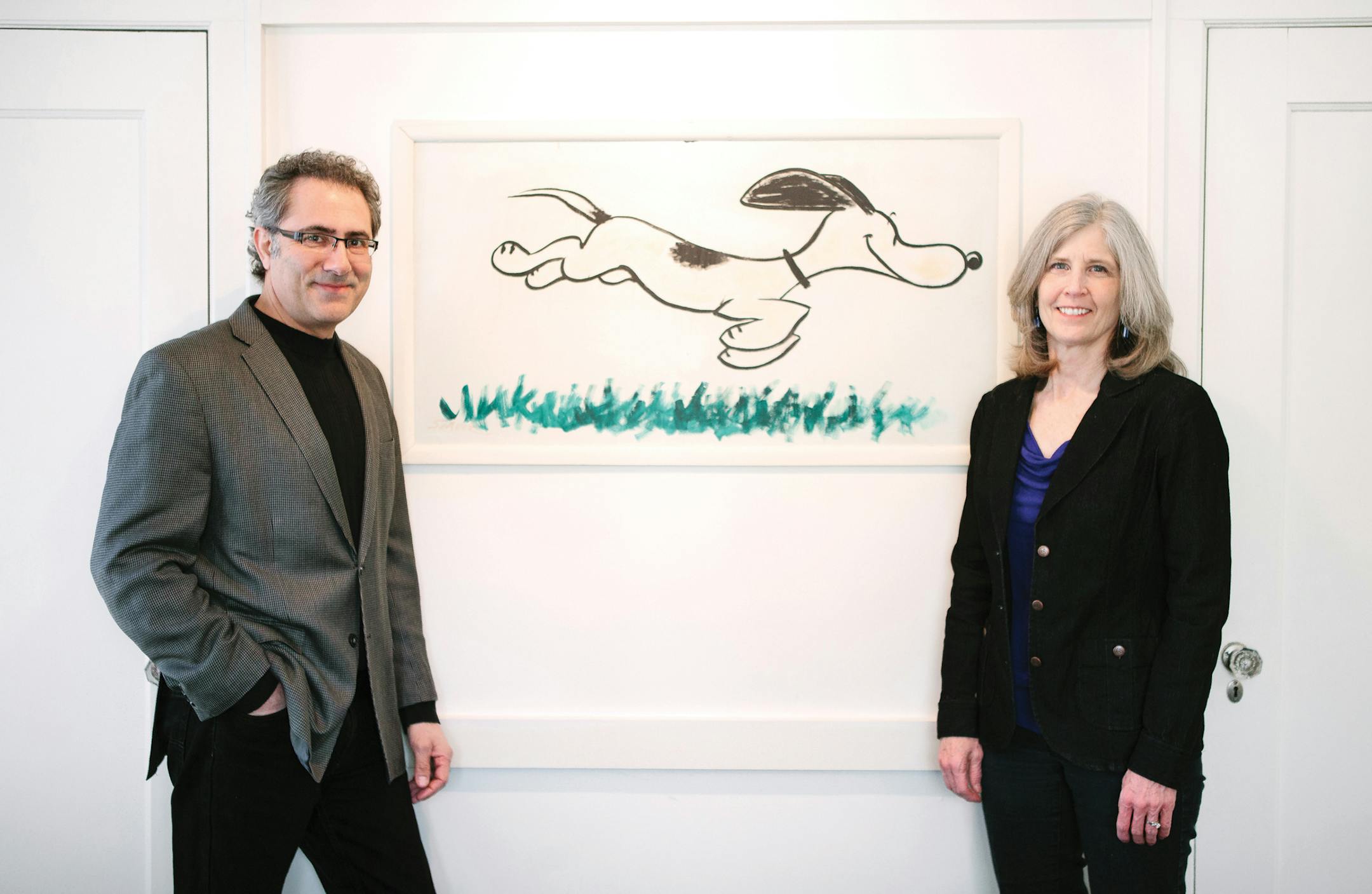 Homeowners Ken and Karen Abdo with the original "Snoopy" painting by Charles Schulz in one of the bedrooms. Credit Wing Ta/Artful living ORG XMIT: MIN1405221153311877