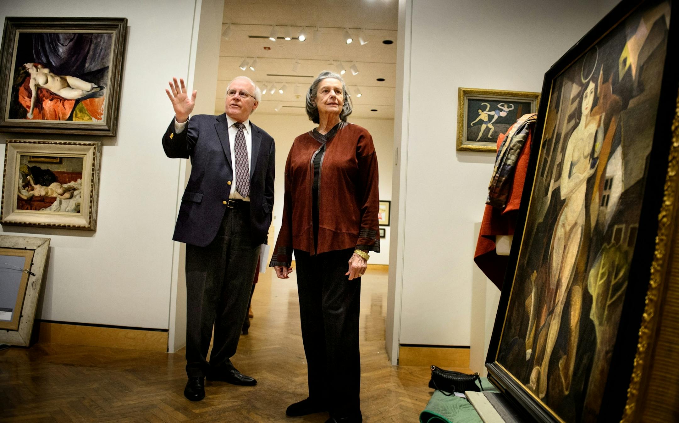 TOTALLY EMBARGOED UNTIL JAN 1, 2015 -- Anita Kunin toured the Minneapolis Institute of Arts exhibit of her late husband's 78 American modernist paintings art collection with MIA curator Patrick Noon.