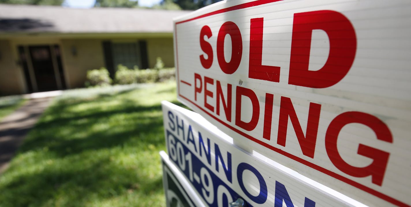 FILE - This June 13, 2019, photo shows a house with a "sold pending" sign fixed on the realtor's sign in northeast Jackson, Miss. On Monday, Dec. 30, the National Association of Realtors releases its November report on pending home sales, which are seen as a barometer of future purchases. (AP Photo/Rogelio V. Solis, File)