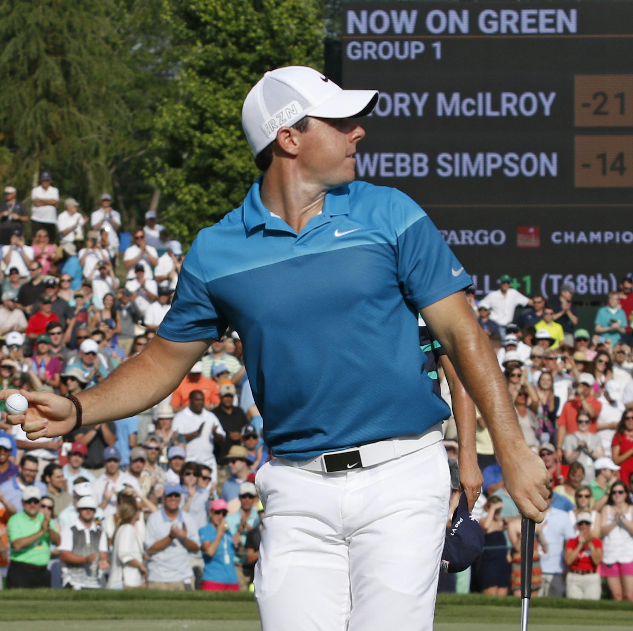 Rory McIlroy, of Northern Ireland, prepares to throw his ball into the crowd as he celebrates after winning the Wells Fargo Championship golf tournament at Quail Hollow Club in Charlotte, N.C., Sunday, May 17, 2015. (AP Photo/Bob Leverone)