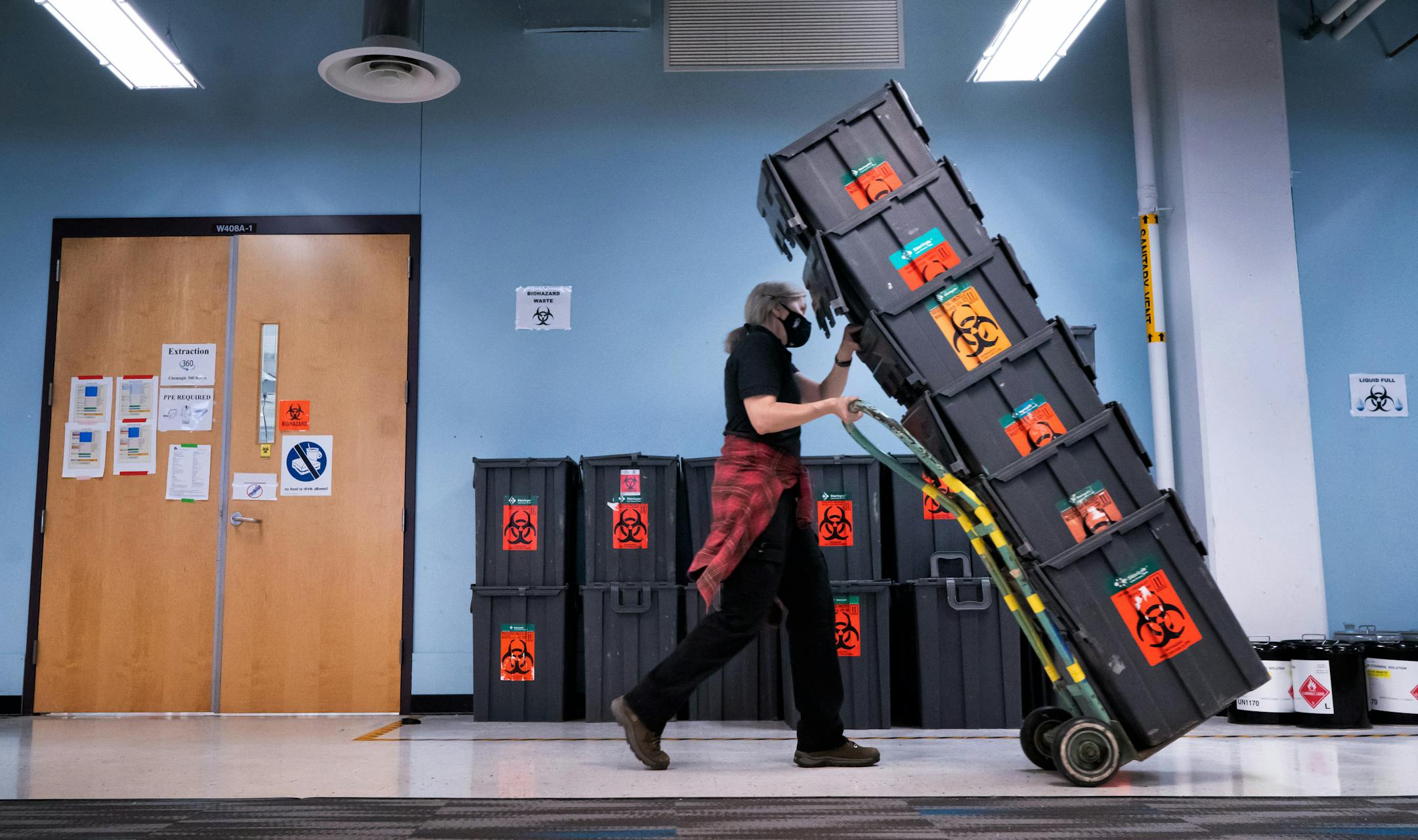Processed samples are saved in ultracold storage boxes for four days, then disposed as biohazard waste along with any supplies that came in contact with the samples. Here empty storage containers are moved into position for use.