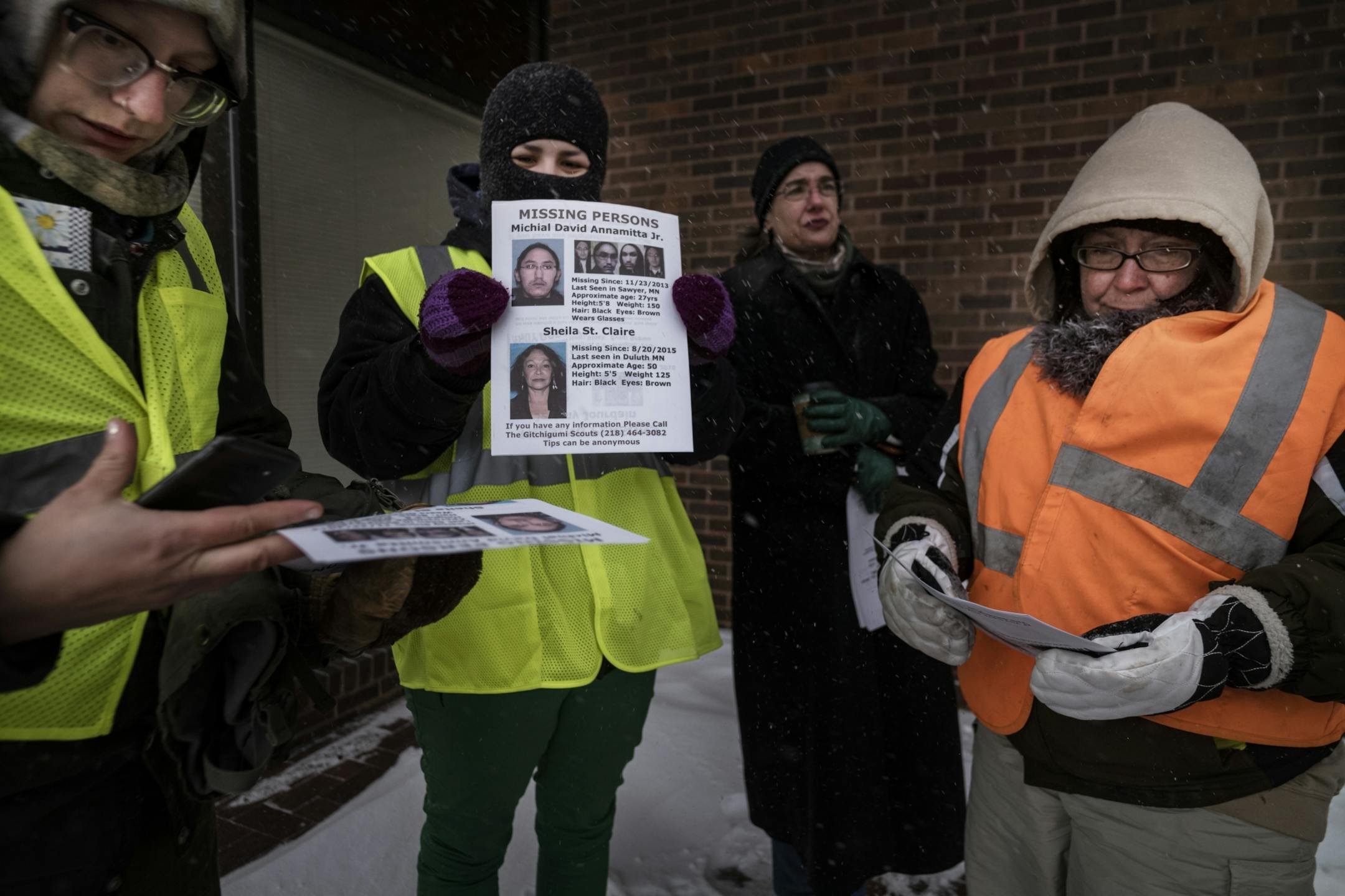 Taysha Martineau, center, held up a sign that the volunteers were posting in downtown Duluth. The other volunteers, left to right are Carol Thicke, Chris Mrozinski, and Toni Branley.