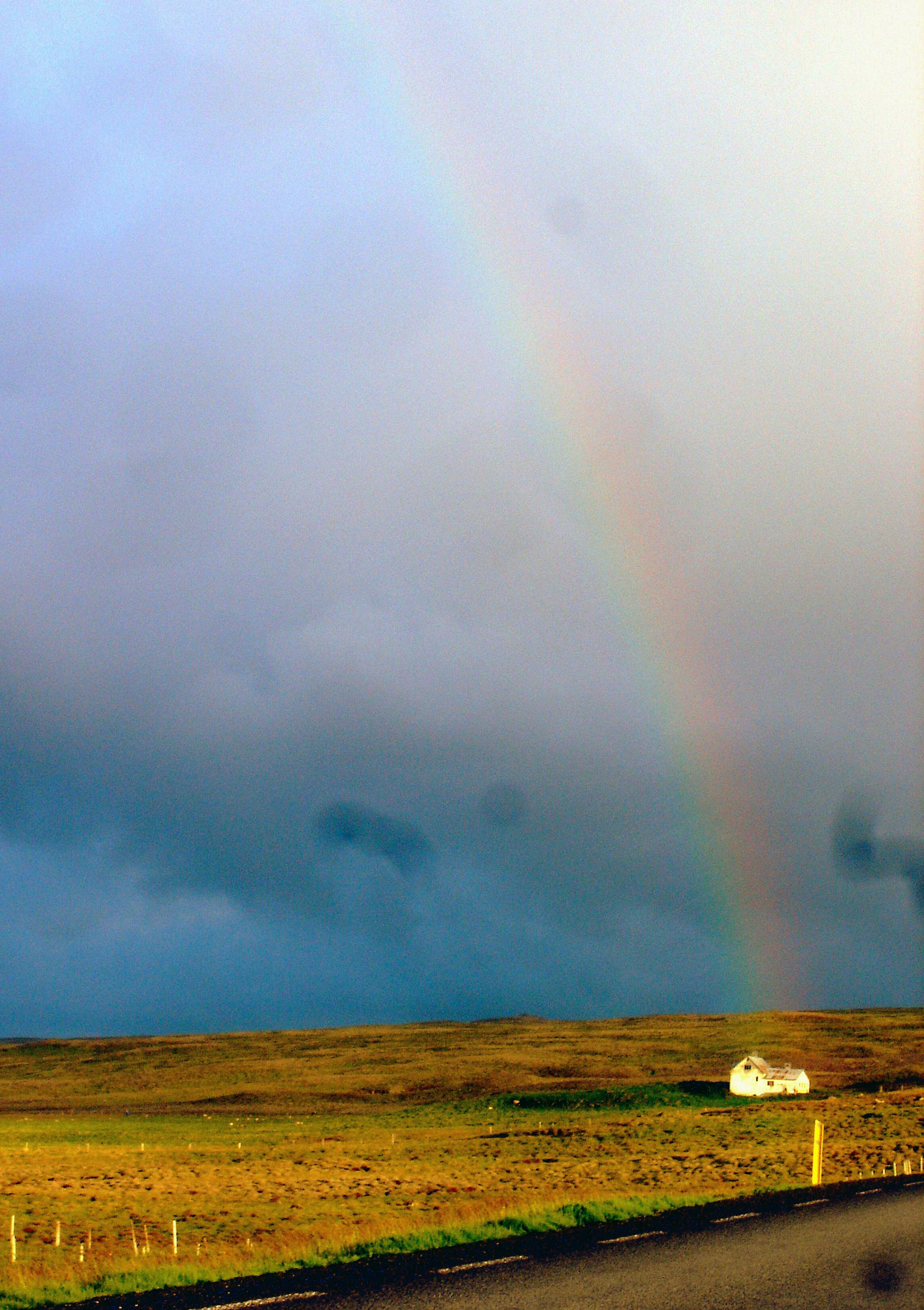 The Ring Road, sometimes alongside a rainbow, traces the Iceland's landscape of tundra, desert, volcanic rock and glaciers.