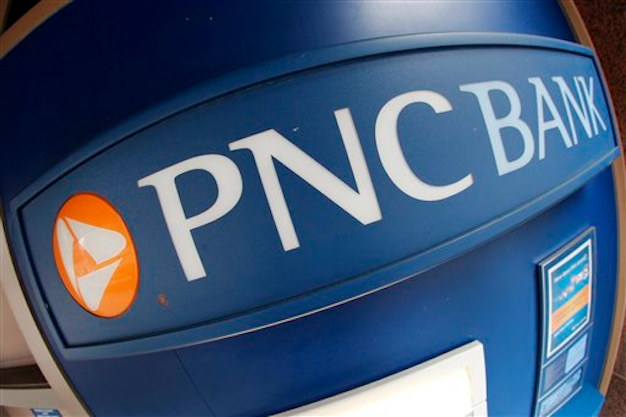 This Jan. 12, 2012 photo taken with a fisheye lens, shows a PNC Bank ATM machine in downtown Pittsburgh. PNC Financial Services Group Inc. said Wednesday, Jan. 18, 2012, that its fourth-quarter net income dropped 43 percent on higher expenses and a comparison to a year-ago stock sale gain, while revenue fell. (AP Photo/Gene J. Puskar)