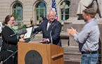 Gov. Tim Walz, visiting Duluth on Thursday, presented a proclamation to Courtney Cochran, left, and Paul Pederson, both involved in St. Louis County�
