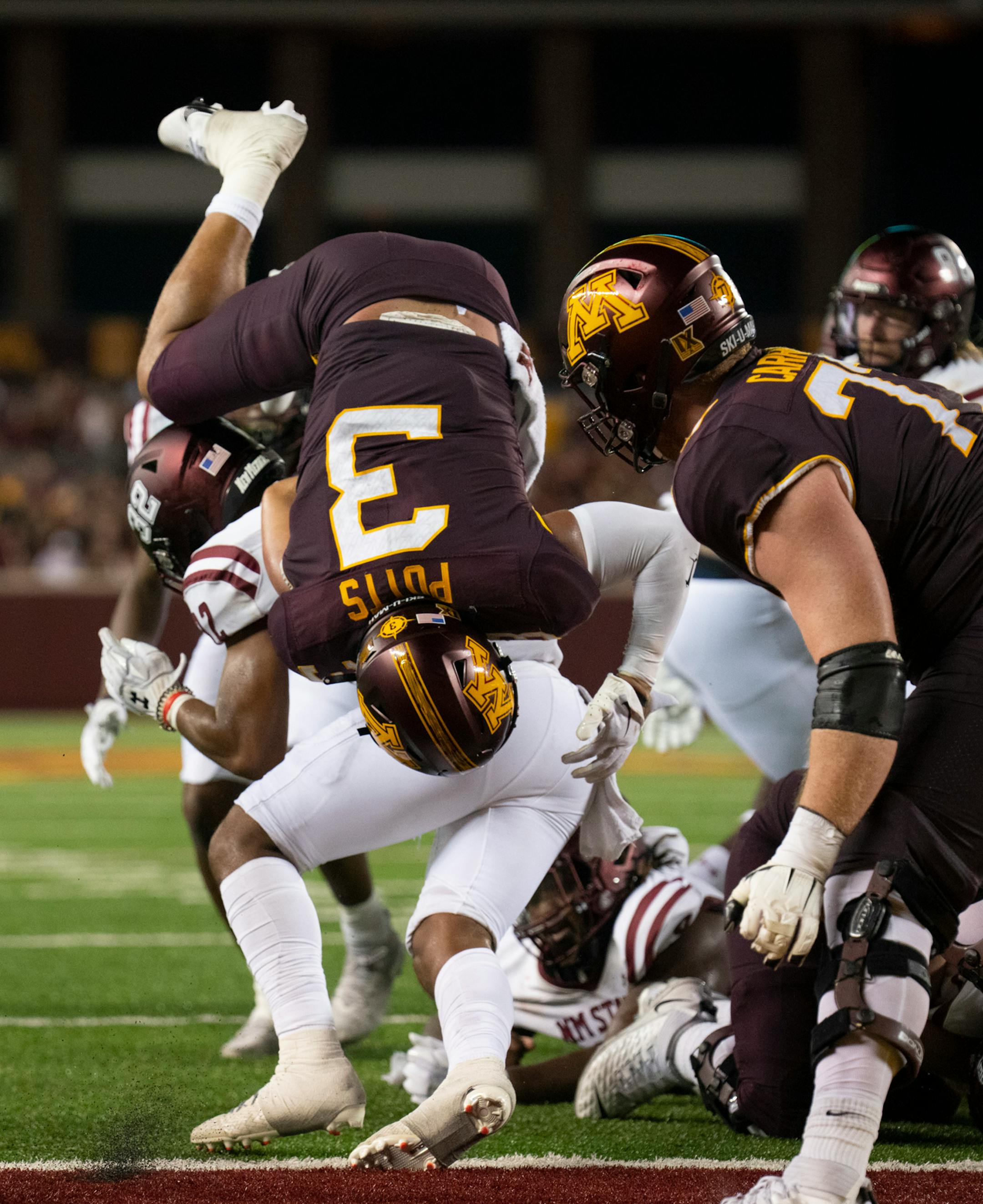 New Mexico State Aggies defensive back Bryce Jackson (32) kept Minnesota Golden Gophers running back Trey Potts (3) just shy of scoring on a third quarter run.
