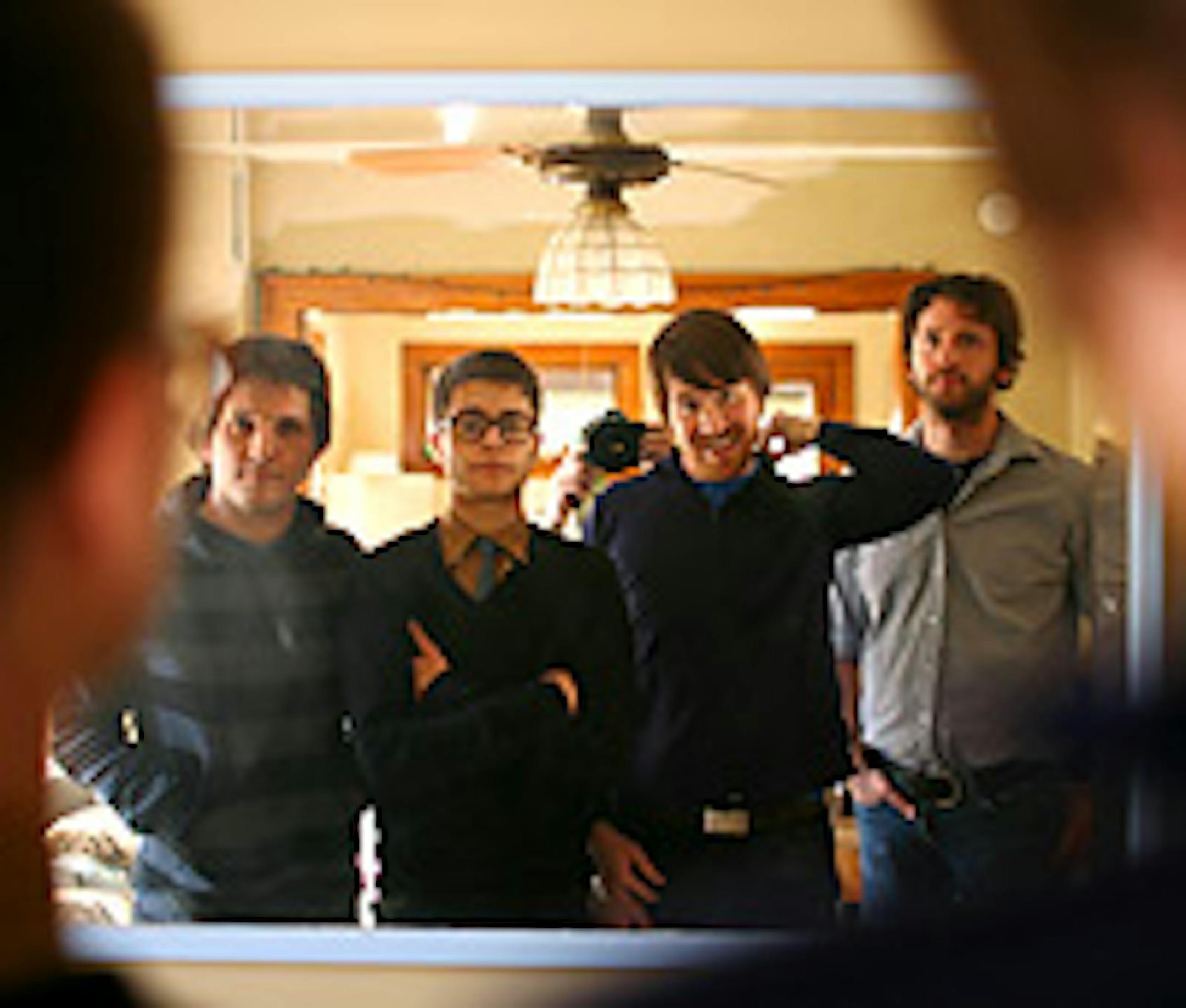 Tapes 'N Tapes, from left (in mirror): keyboardist Matt Kretzmann, drummer Jeremy Hanson, singer/guitarist Josh Grier and bassist Erik Appelwick. They're in Matt Kretzmann's living room.