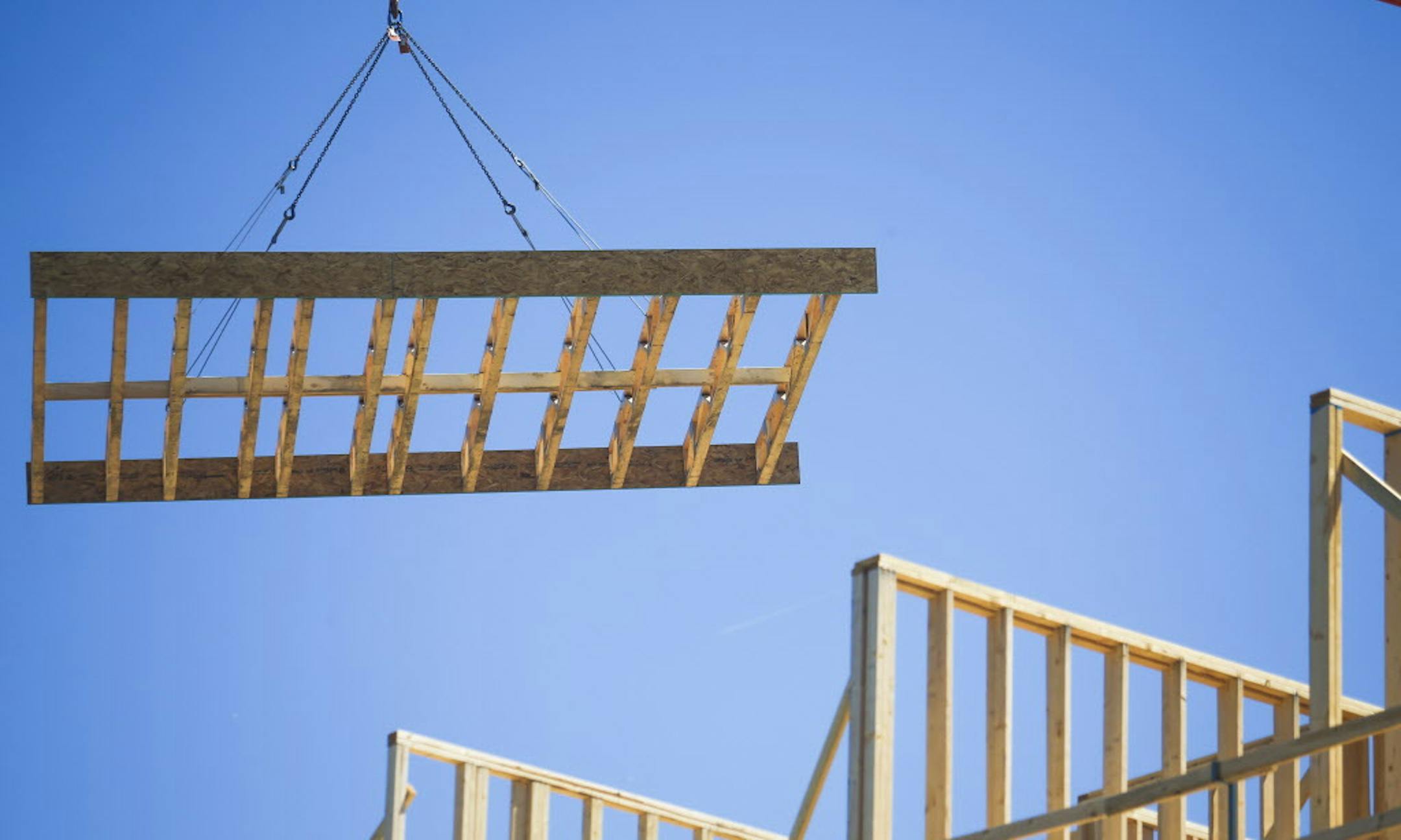 Wood paneling is brought up by a crane to the top level of Hello Apartments. ] Timothy Nwachukwu &#x2022; timothy.nwachukwu@startribune.com Construction work of Hello Apartments is performend on Friday, July 22, 2016. Though the apartment building is scheduled to be completed by December 2016, regulators are exploring whether substandard wood is being used.