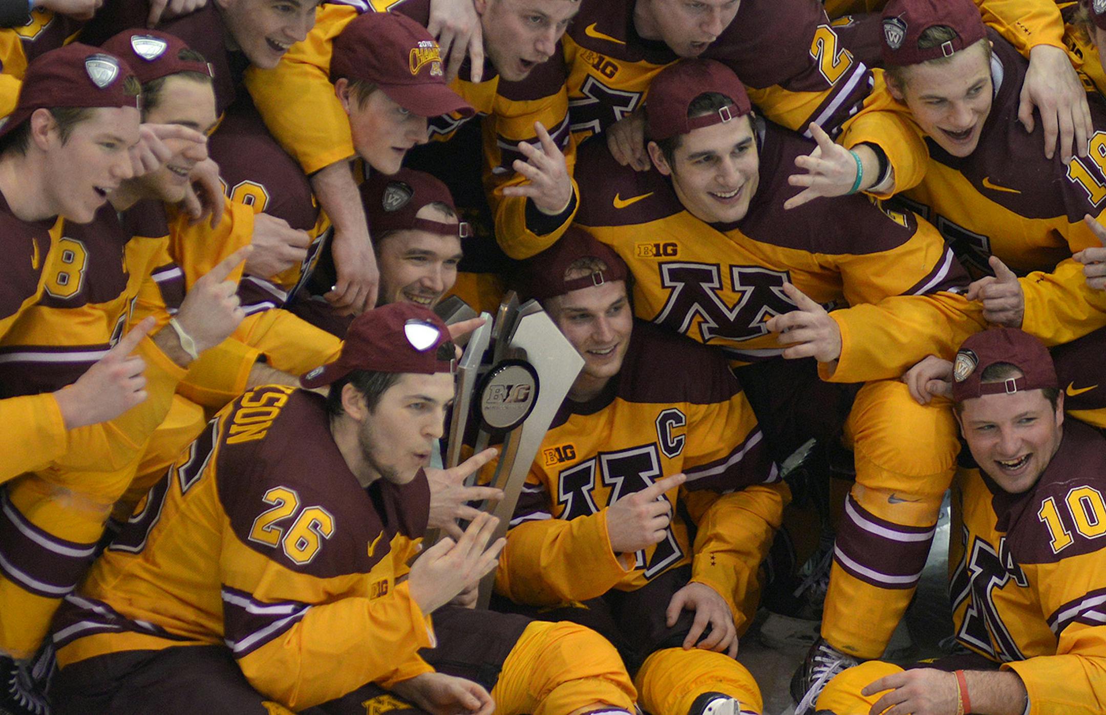 Minnesota teammates pose with their Big Ten Championship trophy following their 6-2 victory over Penn State names the Gophers to 2015 Big Ten champions.