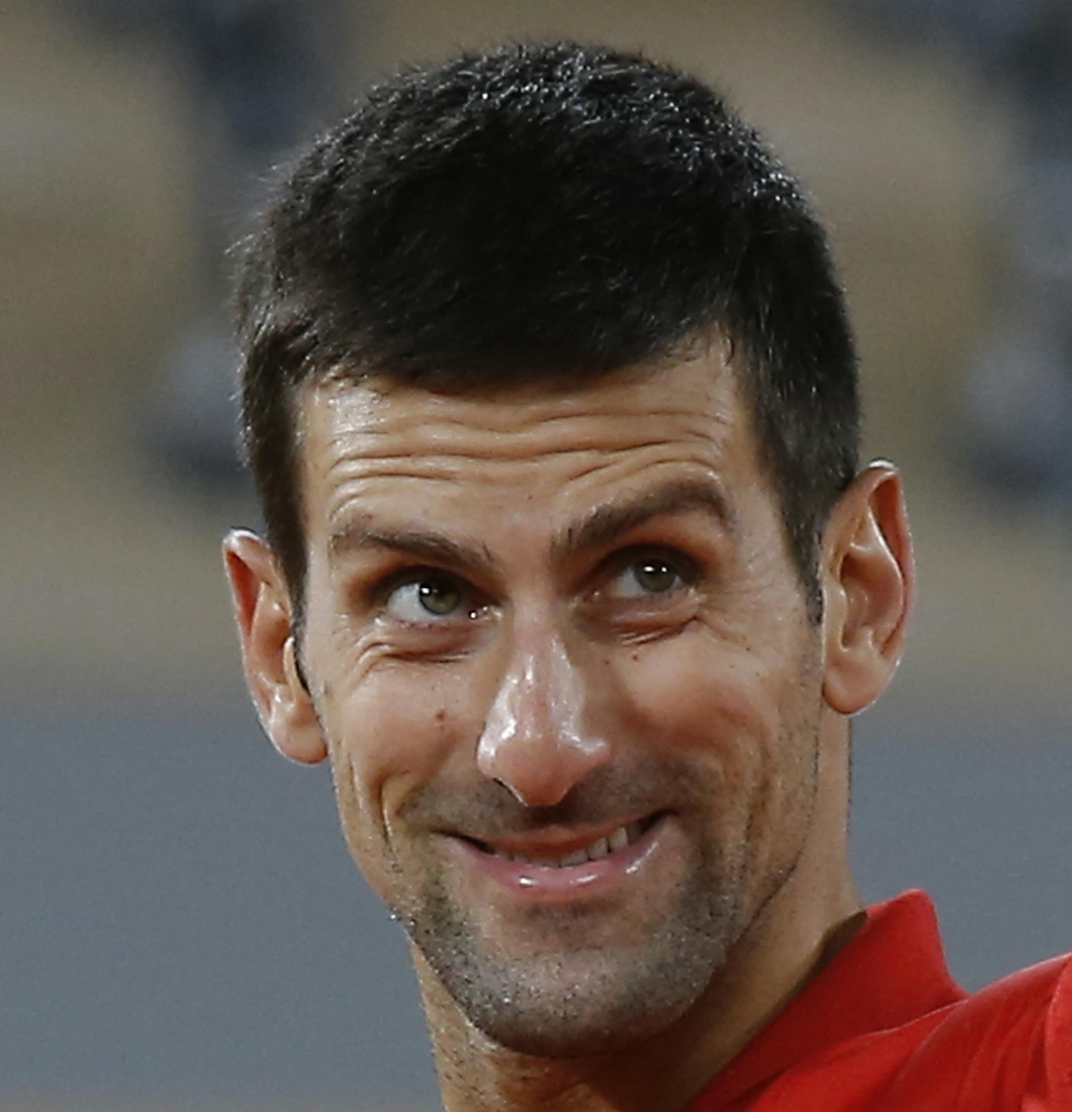 Serbia's Novak Djokovic celebrates winning his semifinal match of the French Open tennis tournament against Greece's Stefanos Tsitsipas in five sets, 6-3, 6-2, 5-7, 4-6, 6-1, at the Roland Garros stadium in Paris, France, Friday, Oct. 9, 2020. (AP Photo/Michel Euler)