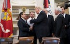 President Donald Trump speaks with Mexico's Economy Minster Ildefonso Guajardo, left, and Foreign Minister Luis Videgaray, second from left, before ca