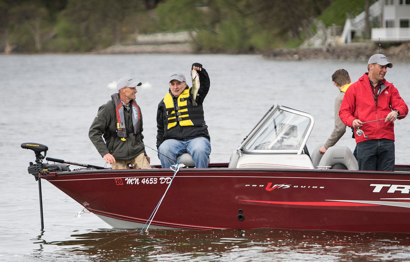 Gov Mark Dayton shows off one of the three fish he caught Saturday morning on Green Lake in Spicer, Minn., during the fishing opener on Saturday, May 12, 2018.