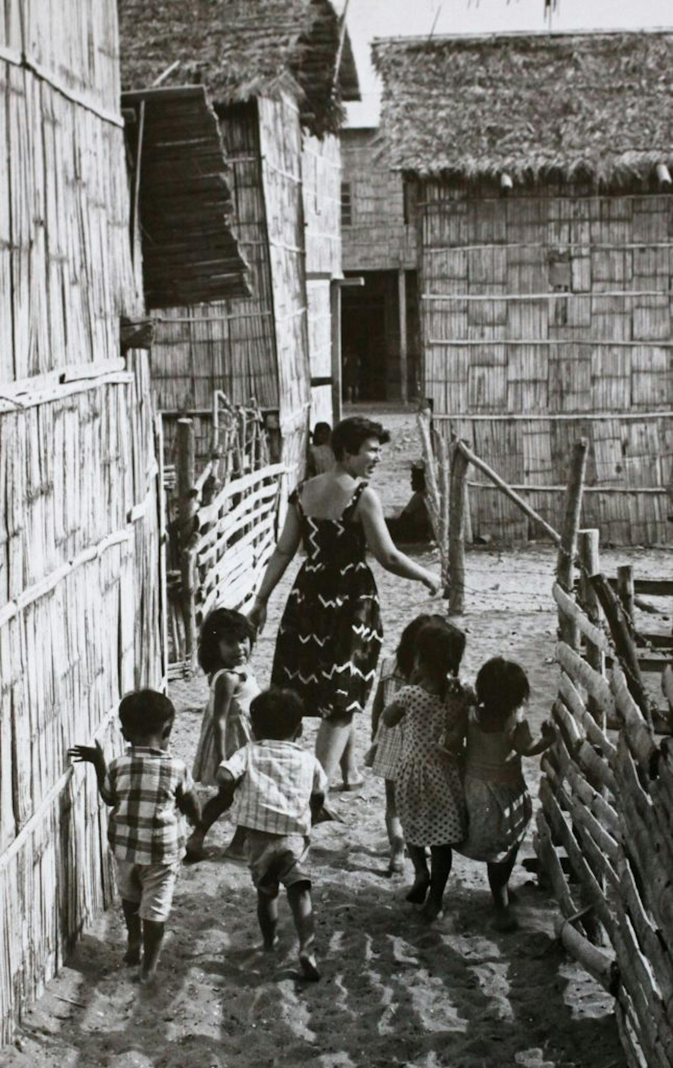 Rhoda Brooks led a group of children while she was stationed in Ecuador. Note the skirt. It was required attire "even when I was laying bricks," she said.