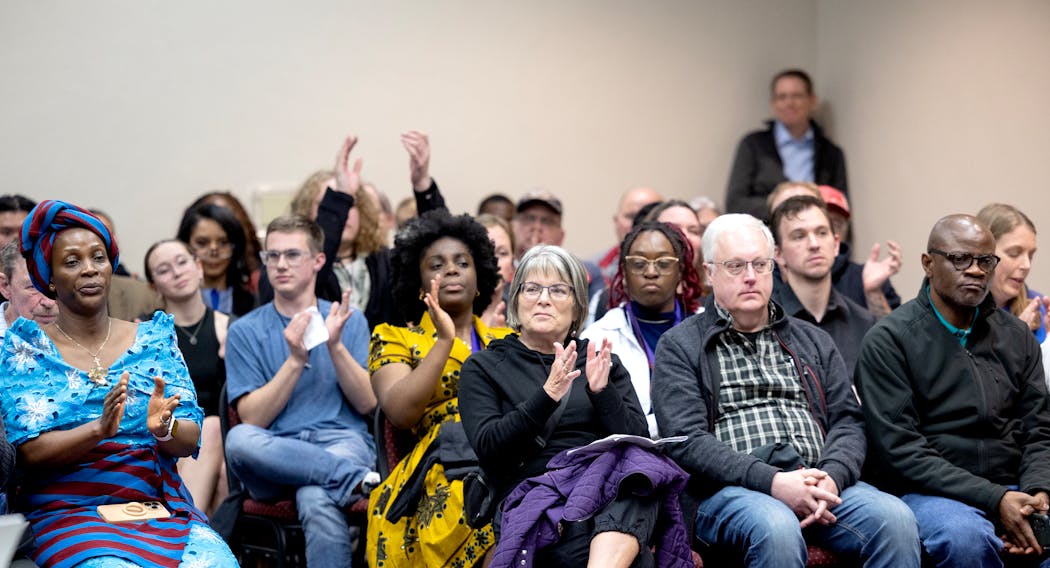 Attendees react after a student spoke to the board during an Anoka-Hennepin School Board meeting on Monday.