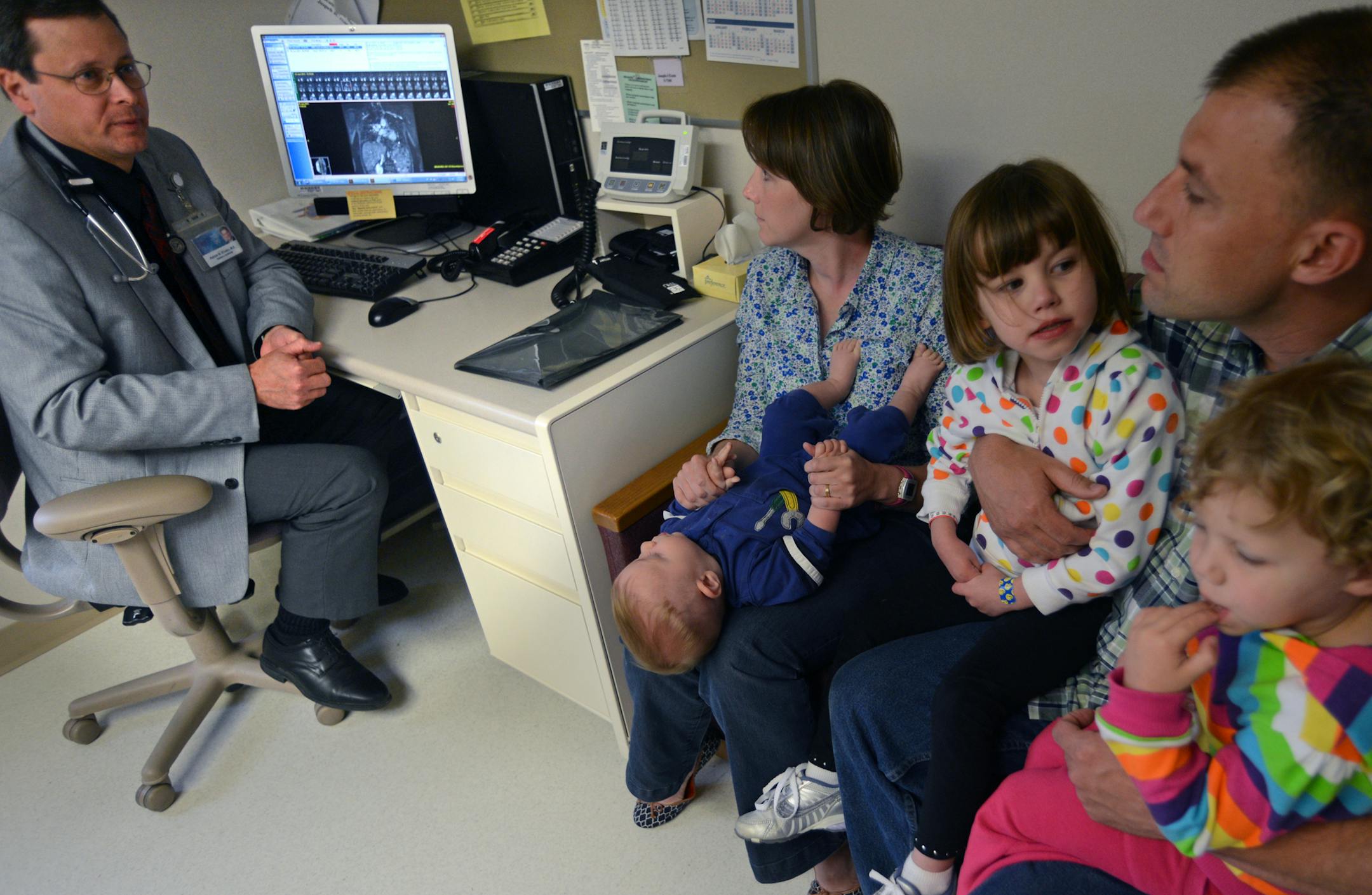 Sandra and Joshua Hughes of Ashburn, Va., listened to Dr. Patrick O’Leary talk about a Mayo study that will use stem cells to repair infant hearts. Daughter Jaclyn, 5, center, was born with a heart defect. She and her parents donated skin tissue for the study.