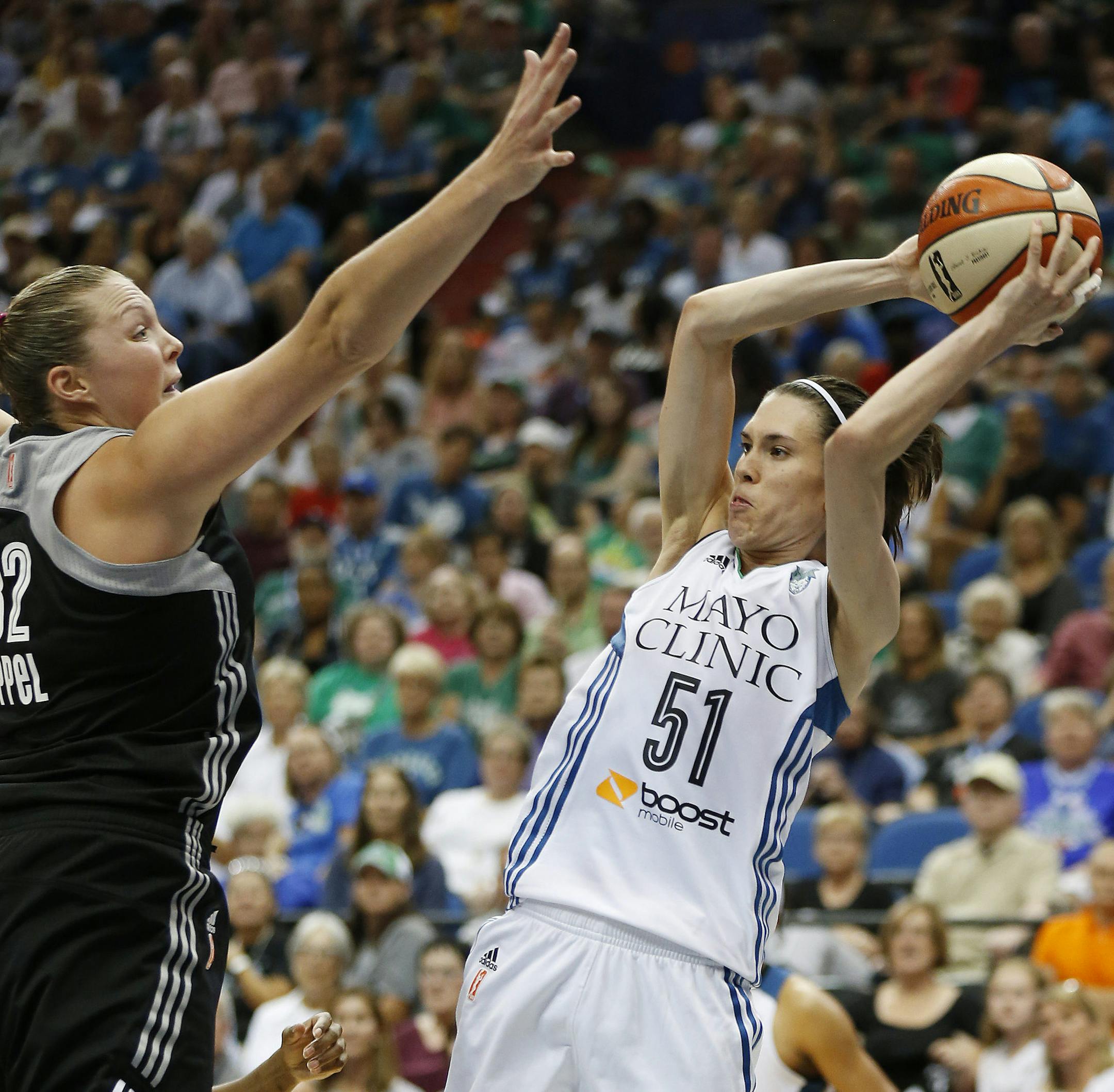 Minnesota Lynx guard Anna Cruz (51) looks to pass the ball against San Antonio Stars center Jayne Appel (32) during the second half of a WNBA basketball game, Tuesday, Aug. 11, 2015, in Minneapolis. The Lynx won 83-76. (AP Photo/Stacy Bengs)