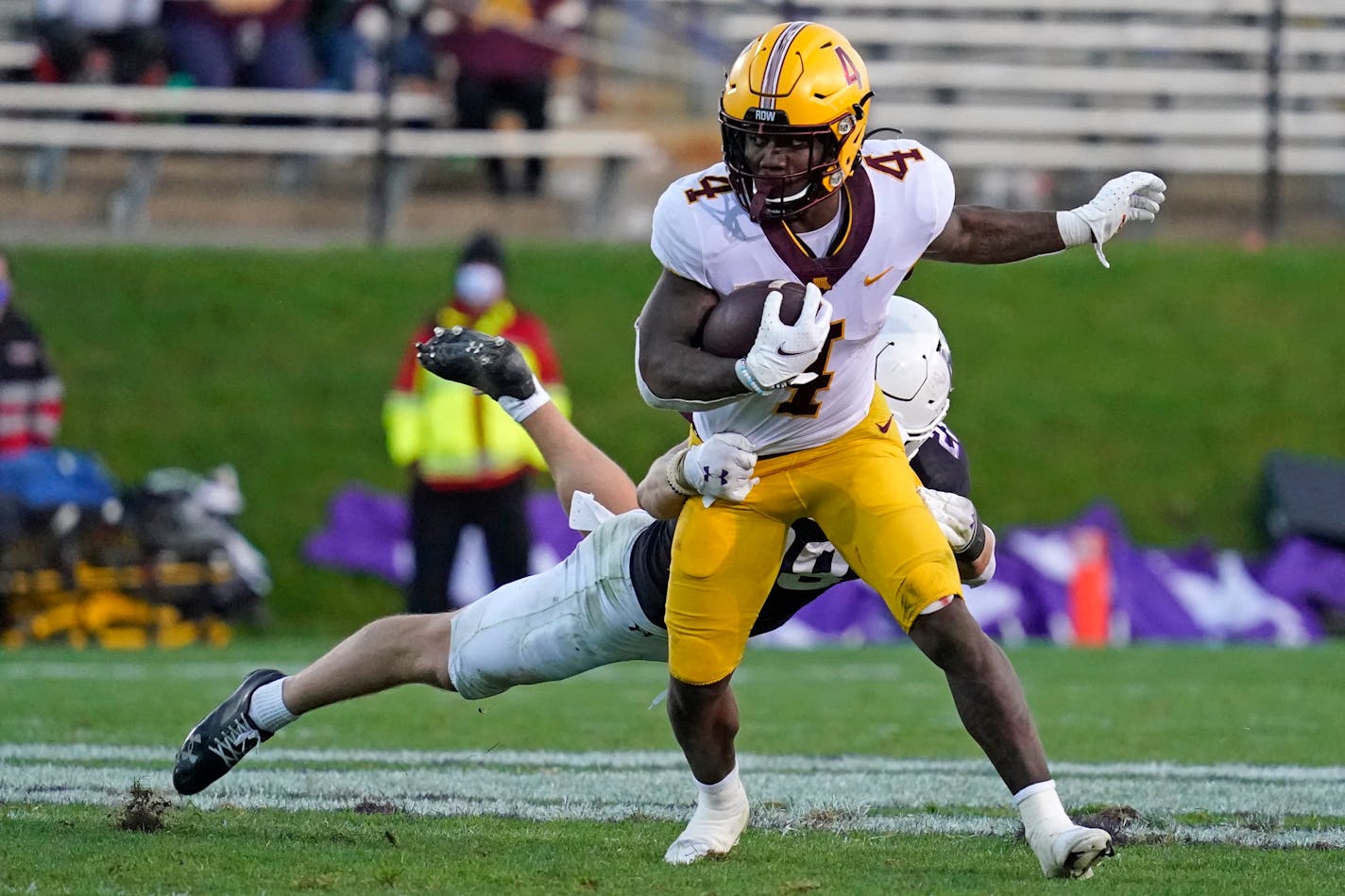 Minnesota running back Mar'Keise Irving (4) is tackled by Northwestern defensive back Bryce Jackson during the second half of an NCAA college football game in Evanston, Ill., Saturday, Oct. 30, 2021. (AP Photo/Nam Y. Huh)