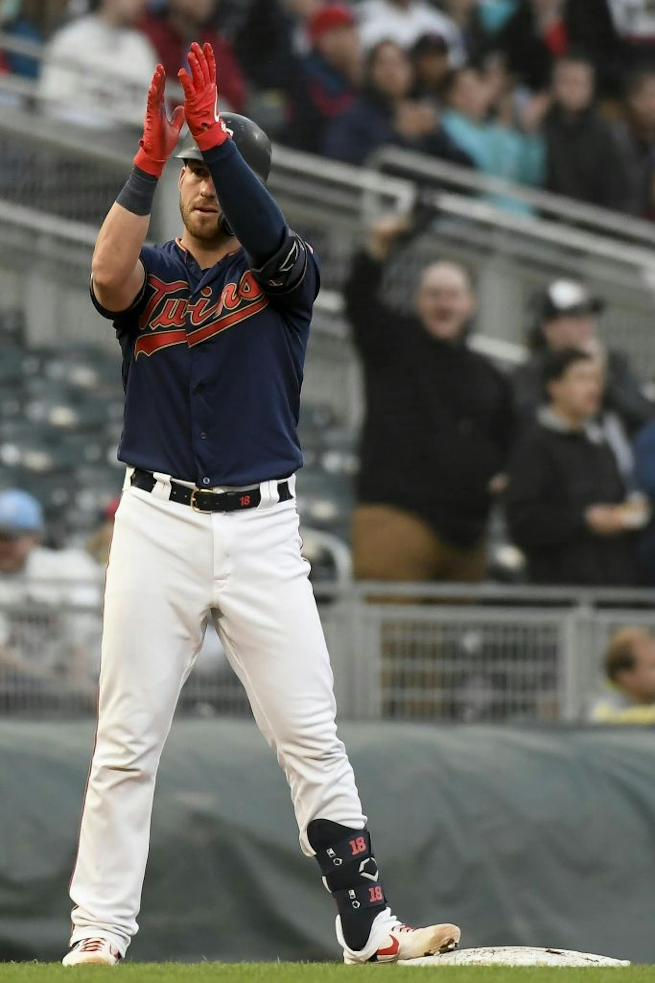 Minnesota Twins catcher Mitch Garver (18) gestured to his teammates after hitting a triple in the bottom of the second inning against the Detroit Tigers.