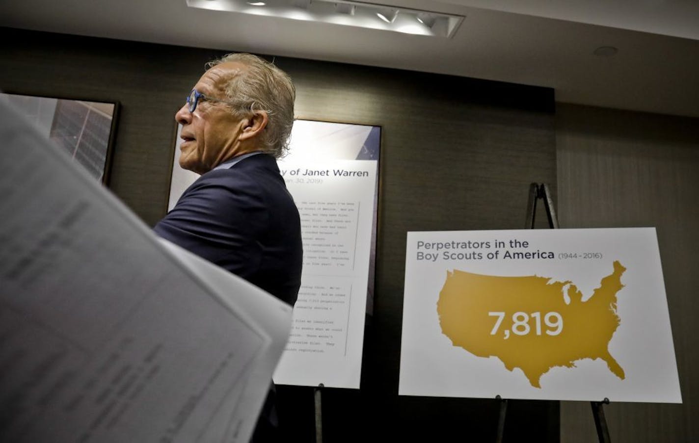 Attorney Jeff Anderson walks past graphics as he prepares to hold a press conference, releasing names of more than 130 Boy Scout leaders who worked in New York and were named in Boy Scouts of America (BSA) "Perversion Files" as having allegations of sexually abusing minors, Tuesday April 23, 2019, in New York.