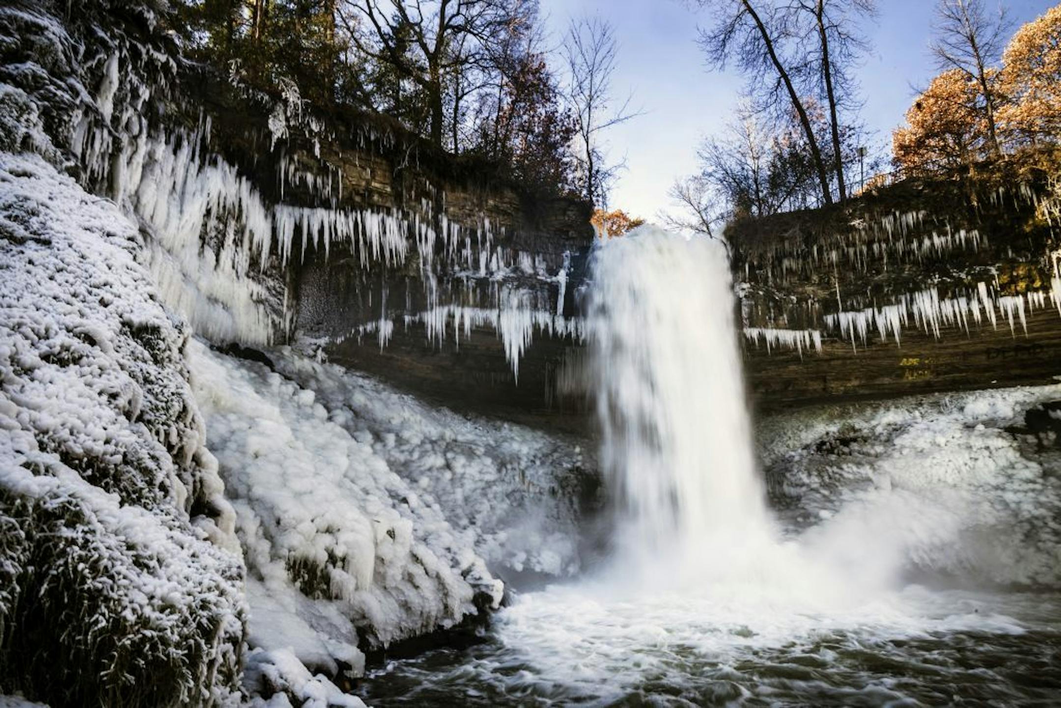 Minnehaha Falls' icy spray began to coat its sides with ice and snow because of the low temperatures Monday, Nov. 11, 2019.